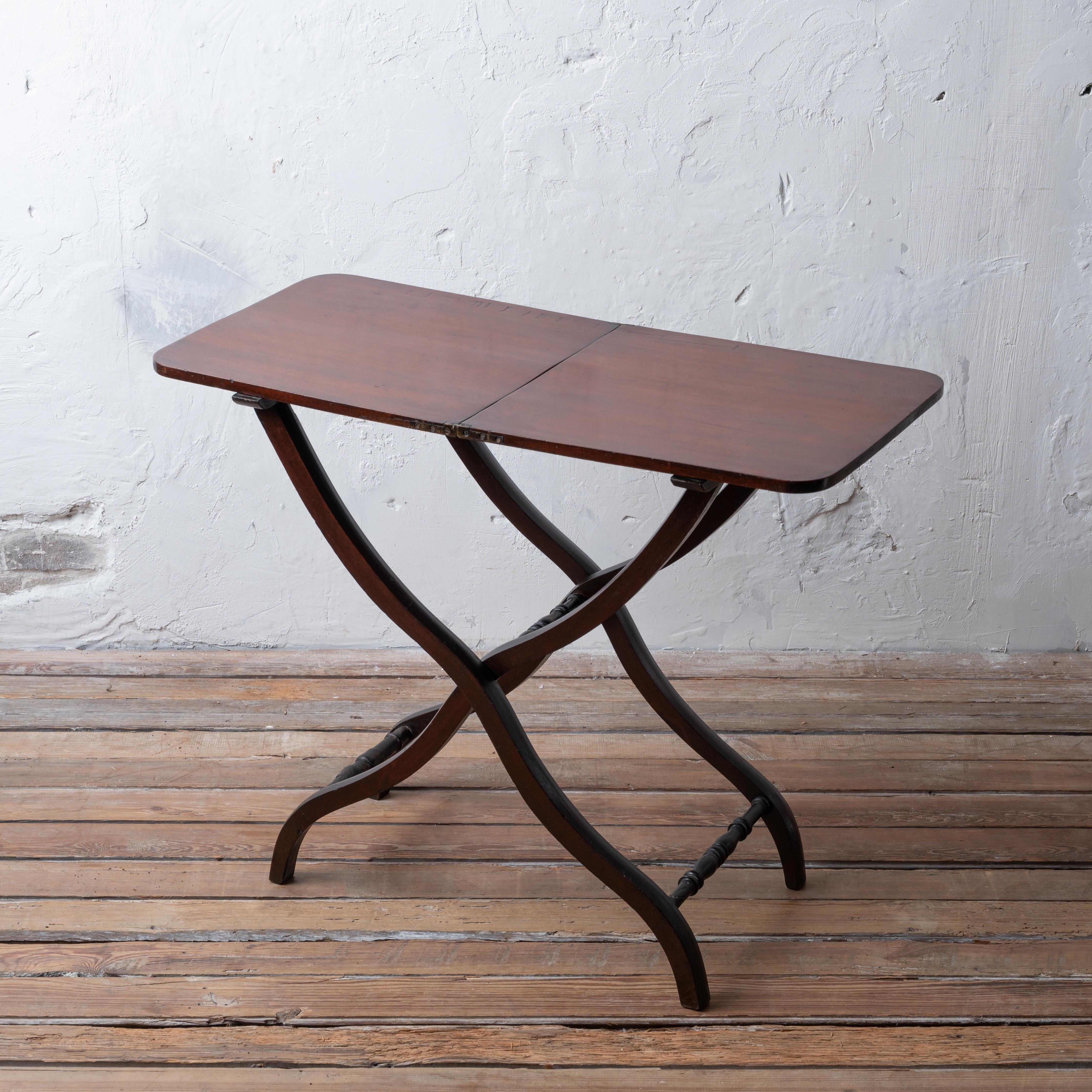 Table à cochonnet pliante en acajou de style Régence anglaise, début du 19e siècle.
La table de coaching a été conçue pour être rangée dans le carrosse afin d'être sortie pour l'heure du thé lors des voyages à travers la campagne.  

33 ¾ pouces de