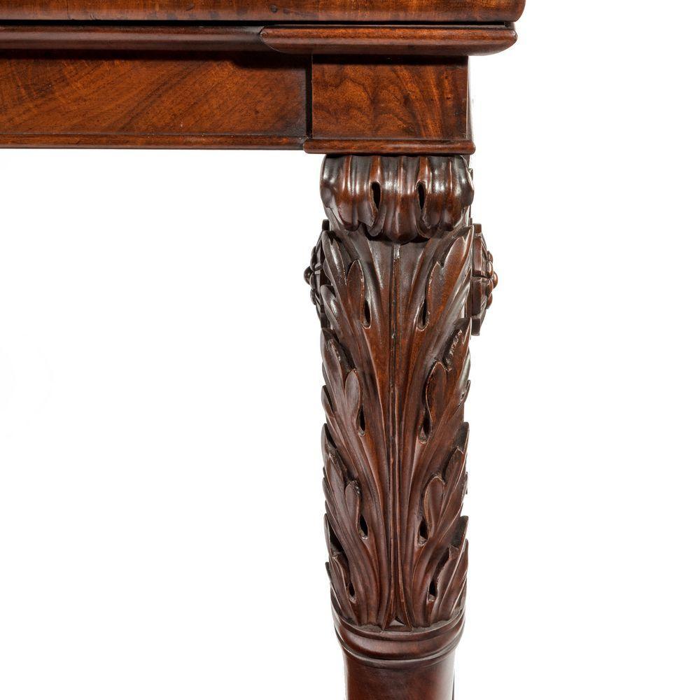 A Regency mahogany console table, of rectangular form with two bold acanthus scroll supports terminating in lion’s paw feet on a gadrooned plinth, English, circa 1815.

The quality of construction, design and choice of timber used this this