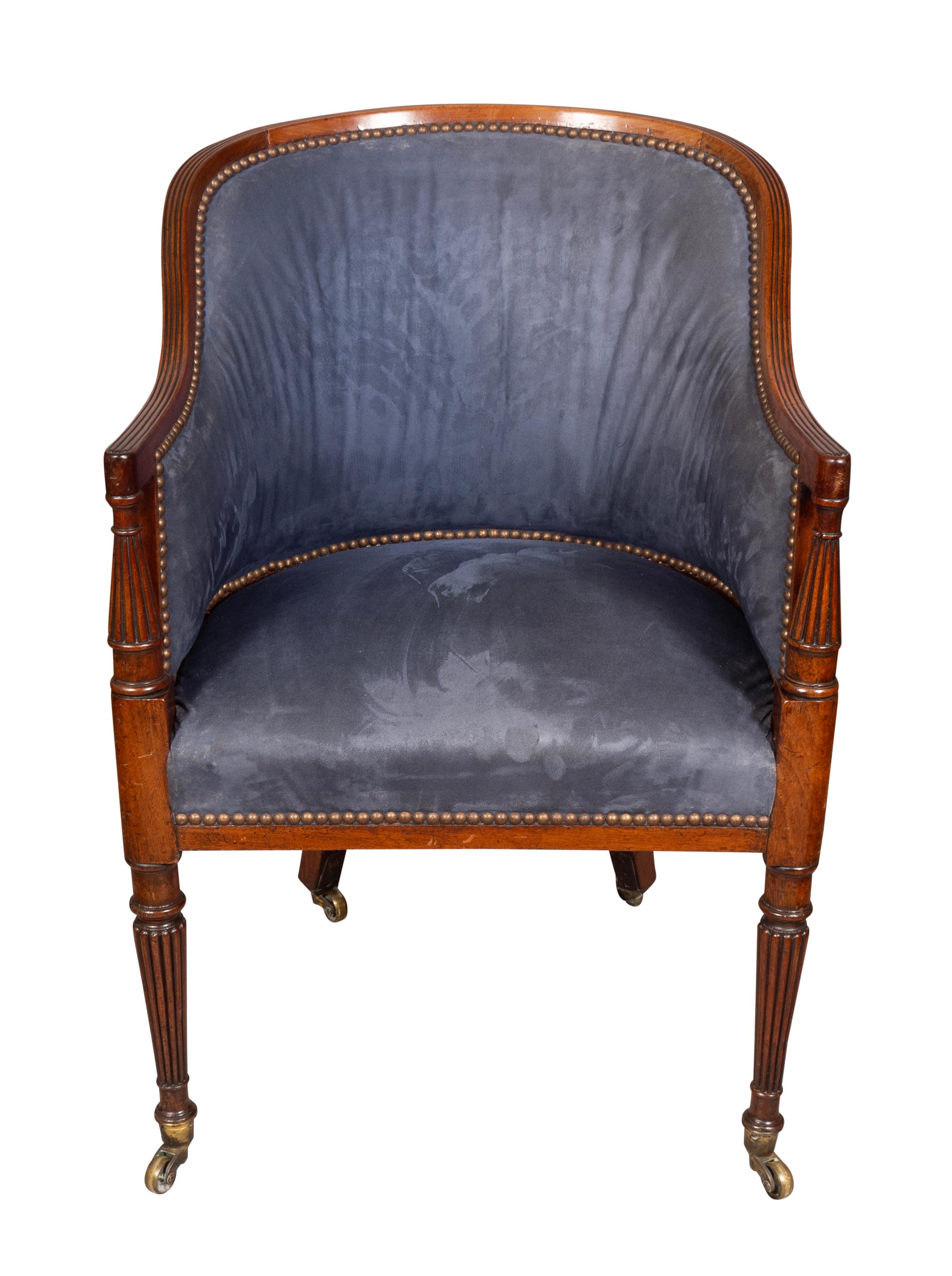 With rounded upholstered back with mahogany frame.The ends of the arms with turned reeded supports. Upholstered seat with tapered reeded legs and ending on casters. Very good condition. Very solid and also comfortable.