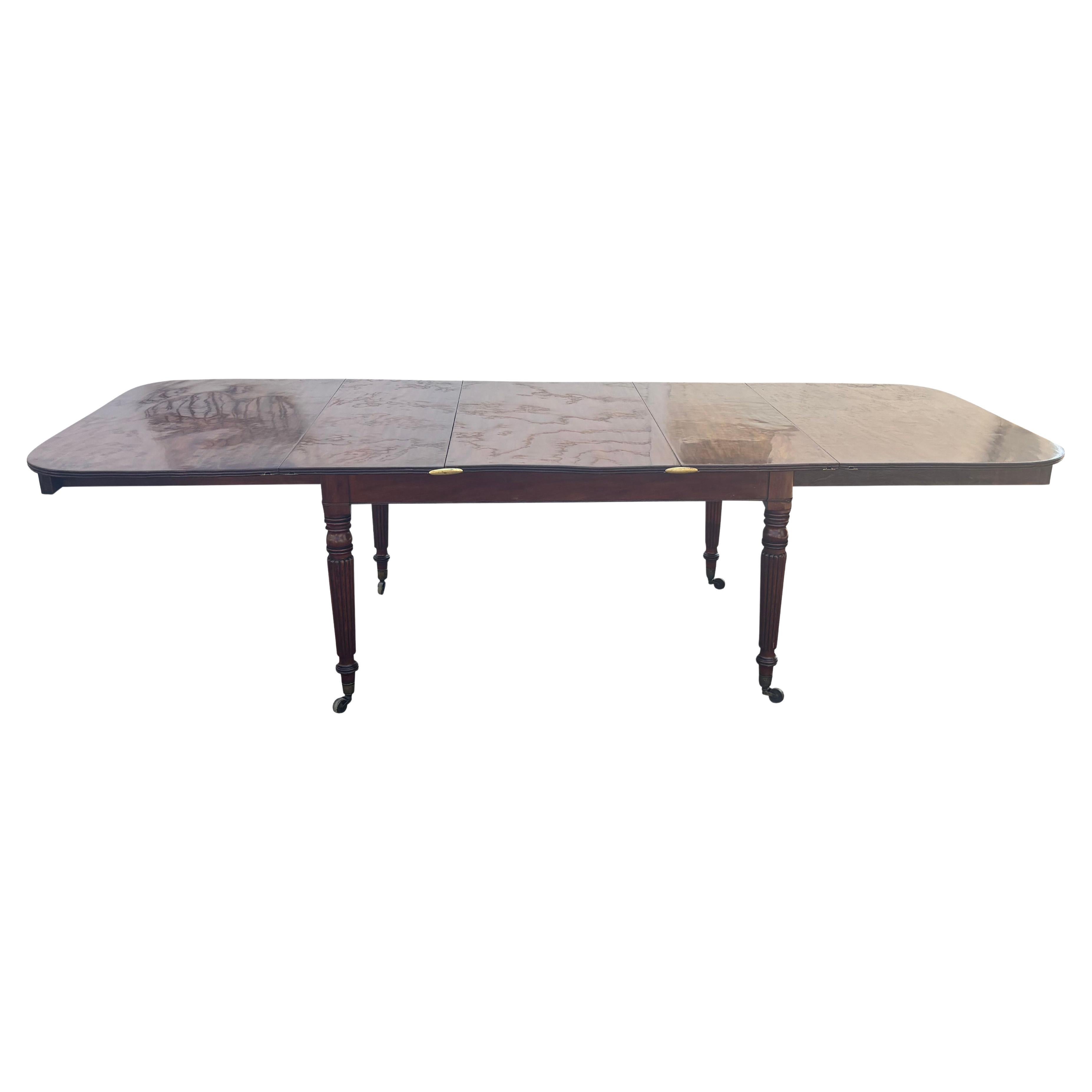 Typically this form was made as campaign furniture but the legs do not unscrew on this table. Wonderful rich patina with three original leaves that can fit inside a compartment when not extended. The rectangular top With brass handles in the frieze