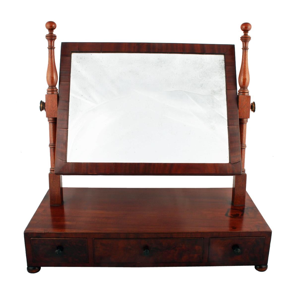 Regency Mahogany Dressing Mirror

A late Regency mahogany swing dressing mirror with ebony line edges.

The original mirror plate is held in a mahogany frame which is suspended between two turned upright supports and held in place with two brass