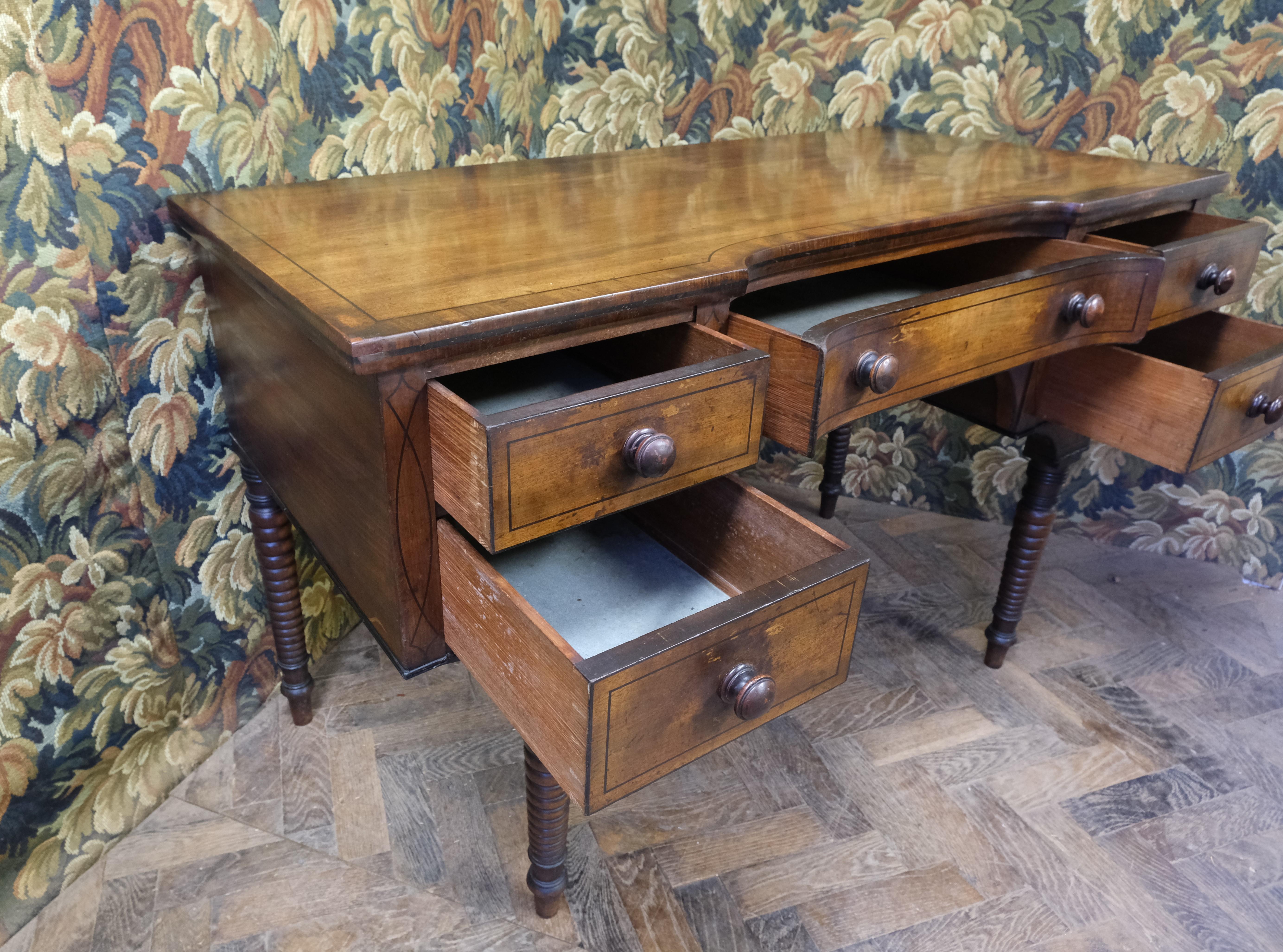 Hutton-Clarke Antiques is thrilled to showcase a distinguished and rare Regency Dressing Table from circa 1800, boasting exquisite craftsmanship in fine mahogany with solid drawer linings. This piece captivates with its figured timber top, elegantly