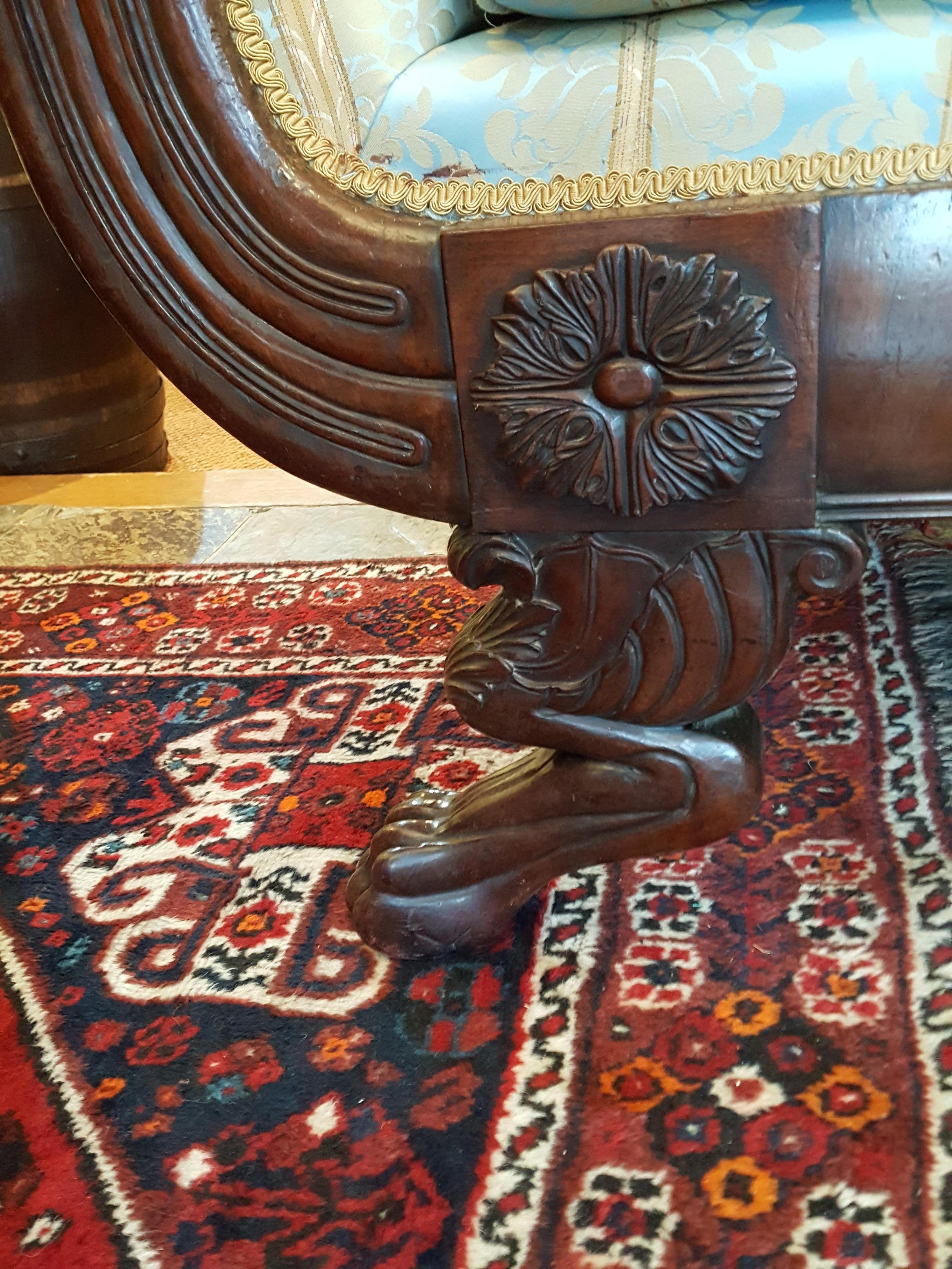 Regency mahogany framed sofa with bulbous scroll arms carved with acanthus leaves, cabriole legs with claw feet, carved rosettes to the frame and shell carved top rail. Irish, circa 1820. Measures: 30 98