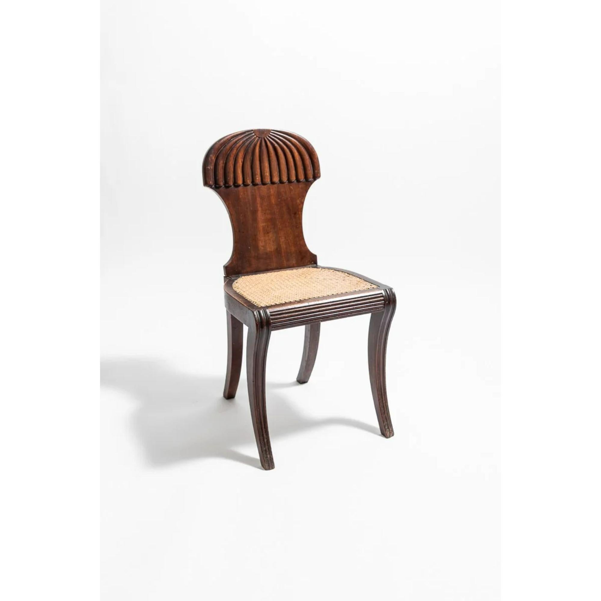 Regency mahogany hall chair by Gillows, circa 1815

The waisted backrest with arched top over relief carved descending lobes, with canework seat above sabre front and splayed back legs, stamped gillows to underside.

Dimensions: H 85cm x W 41cm.
