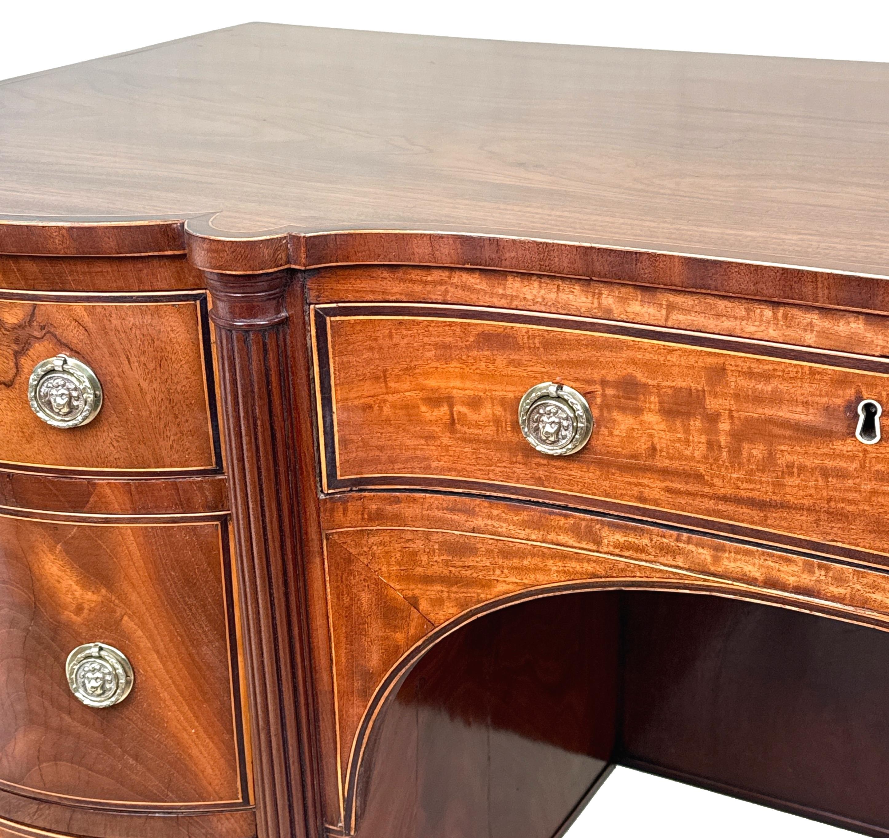 An Exceptional Quality Early 19th Century, Regency Period, Mahogany Dressing Table, Or Kneehole Desk, Having Superbly Figured Shaped Top With Attractive Crossbanded Decoration, Over Shaped Front With Concave Centre, Incorporating 5 Drawers And
