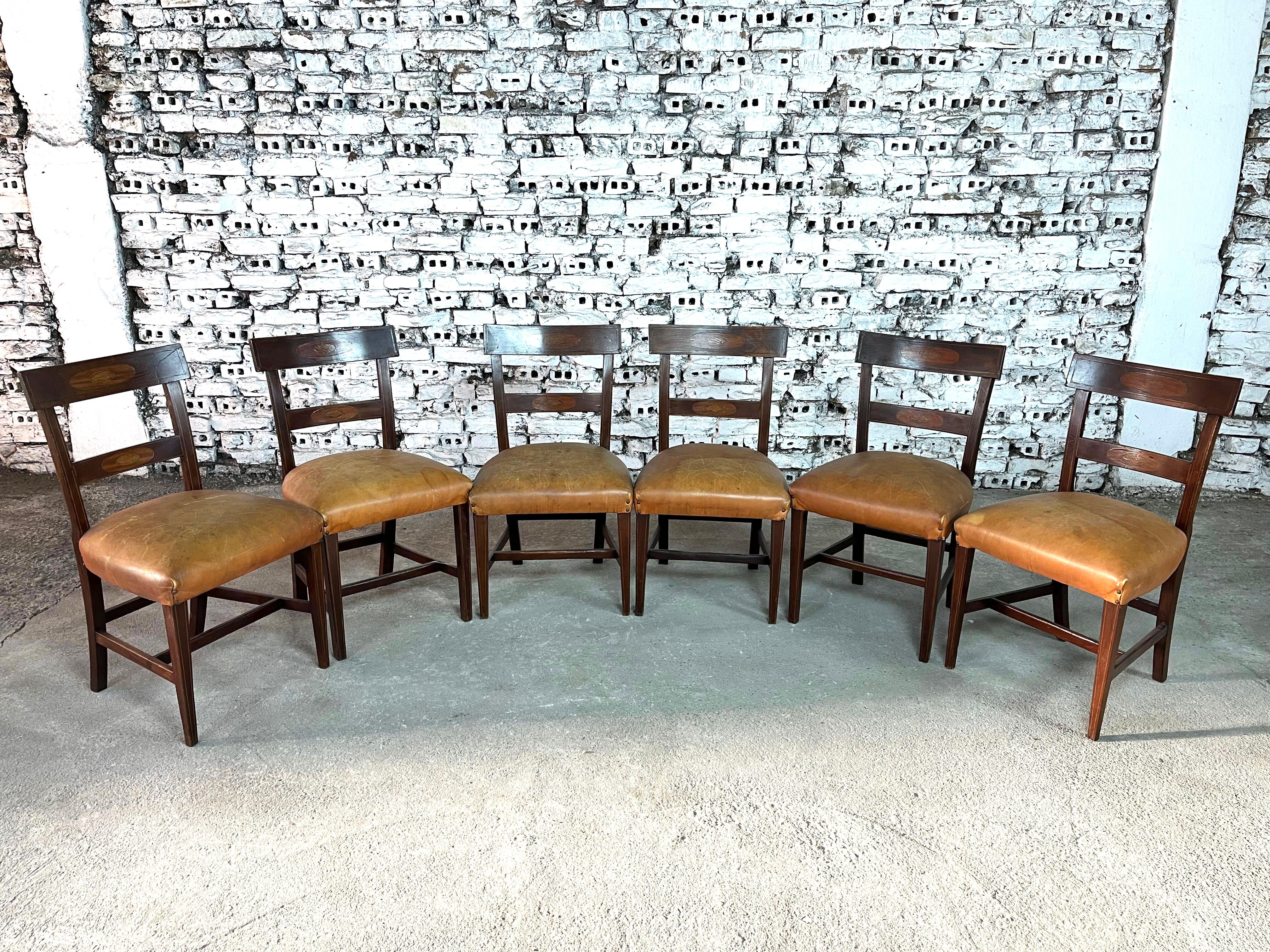 Dimensions: H 33.2” x W 18.5” x D 16.9” x SH 18.5”

Set of 6 antique Regency period inlaid mahogany bar-back dining chairs. Comfortable back rests and original distressed brown leather seats. Raised on tapered legs with understretcher.


Please see