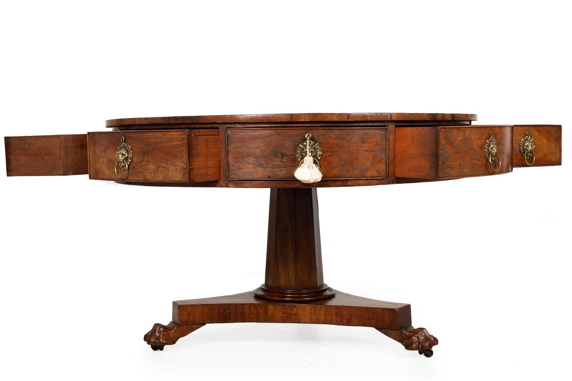 REGENCY MAHOGANY AND TOOLED-LEATHER DRUM OR RENT TABLE
England, ca. 2nd quarter of 19th century  over animal paw feet, retaining original lion mask pulls
Item # 306SEG14A
A bold and powerful circular rent table from the Regency period, it features a