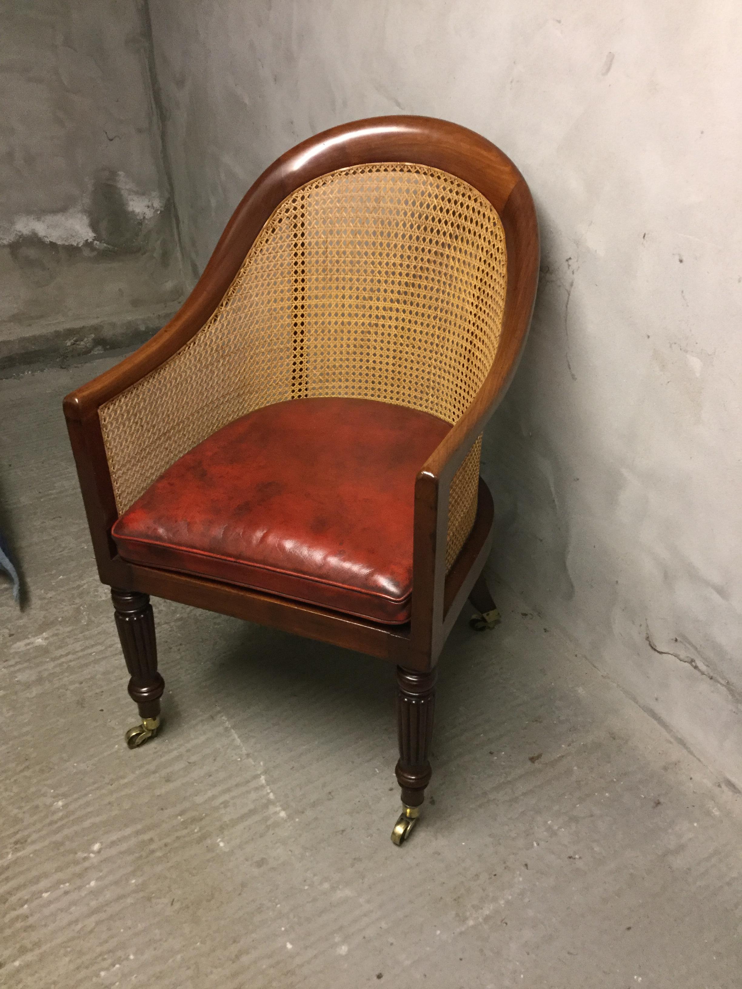 The mahogany Regency period bergere tub chair has recently been re-upholstered.