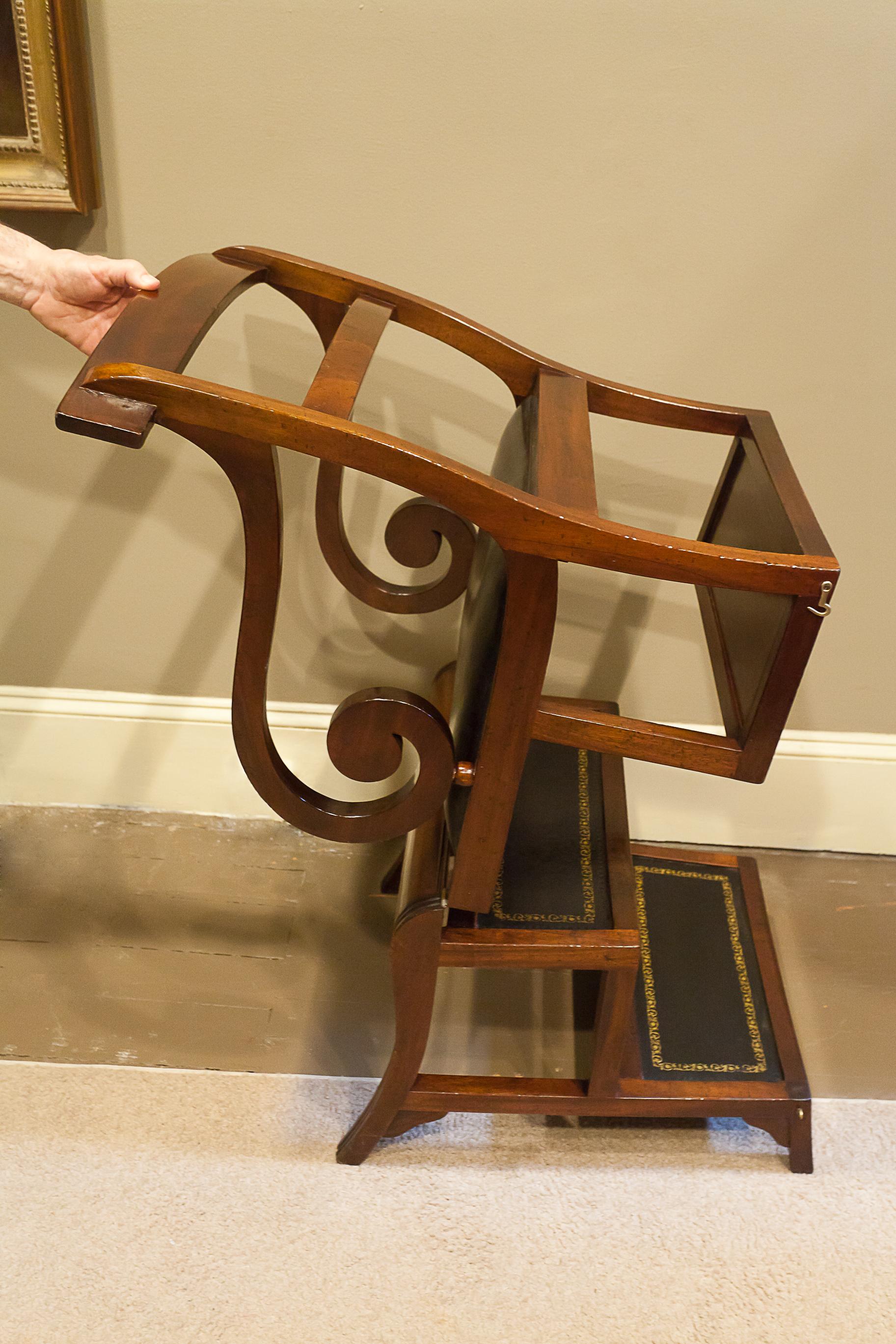 This chair opens out to transform into library steps. There are latches that hold the chair secure when upright. The seat and step treads are black leather; the treads are embossed with gold leaf decoration. The chair has a nice mellow French