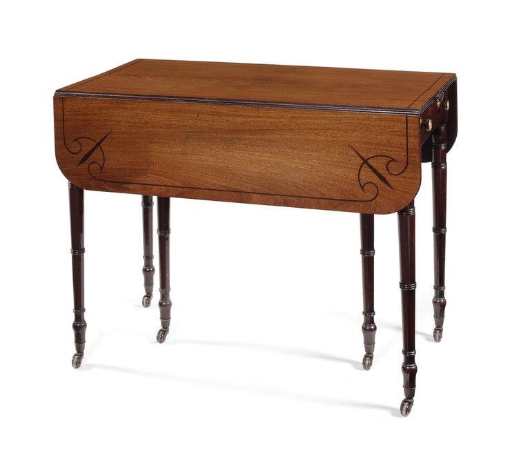 Rare Regency mahogany and ebony line inlaid metamorphic Pembroke dining table
The rectangular top with stylized line inlay and two hinged flaps dividing to the centre with a concertina action to accommodate two additional leaves, on six ring turned