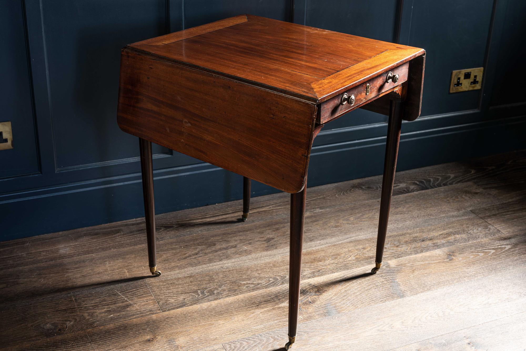 Regency Mahogany Pembroke table. English, early 19th century.
An elegant piece of furniture in perfect proportion. Delicate tapered legs sat upon the tiniest original brass castors, with decorative corner spandrels. Oak lined drawer with original