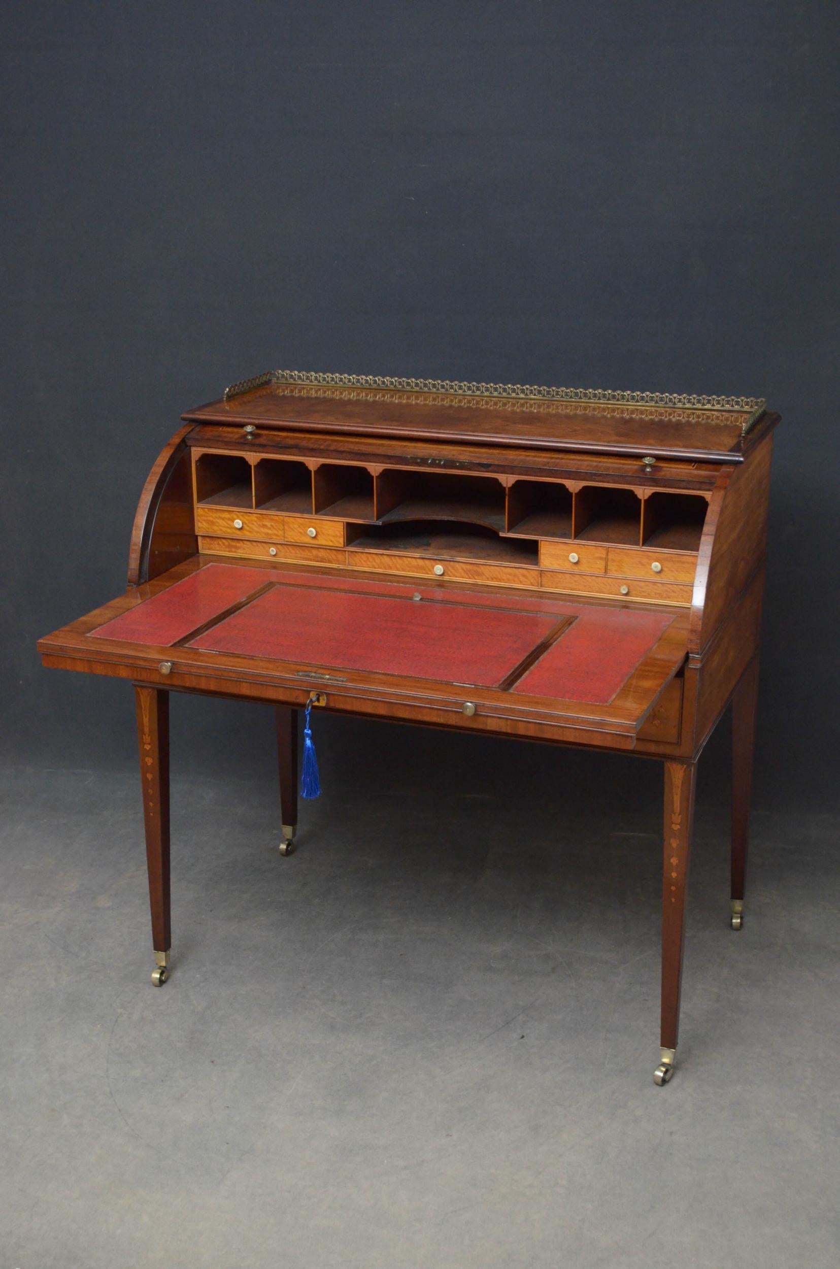 Sn4897, fine quality Regency bureau, having original brass gallery to figured mahogany top above finely inlaid roll top which opens to reveal arrangement of pigeon holes, satinwood drawers and slide out adjustable leather writing surface, all above