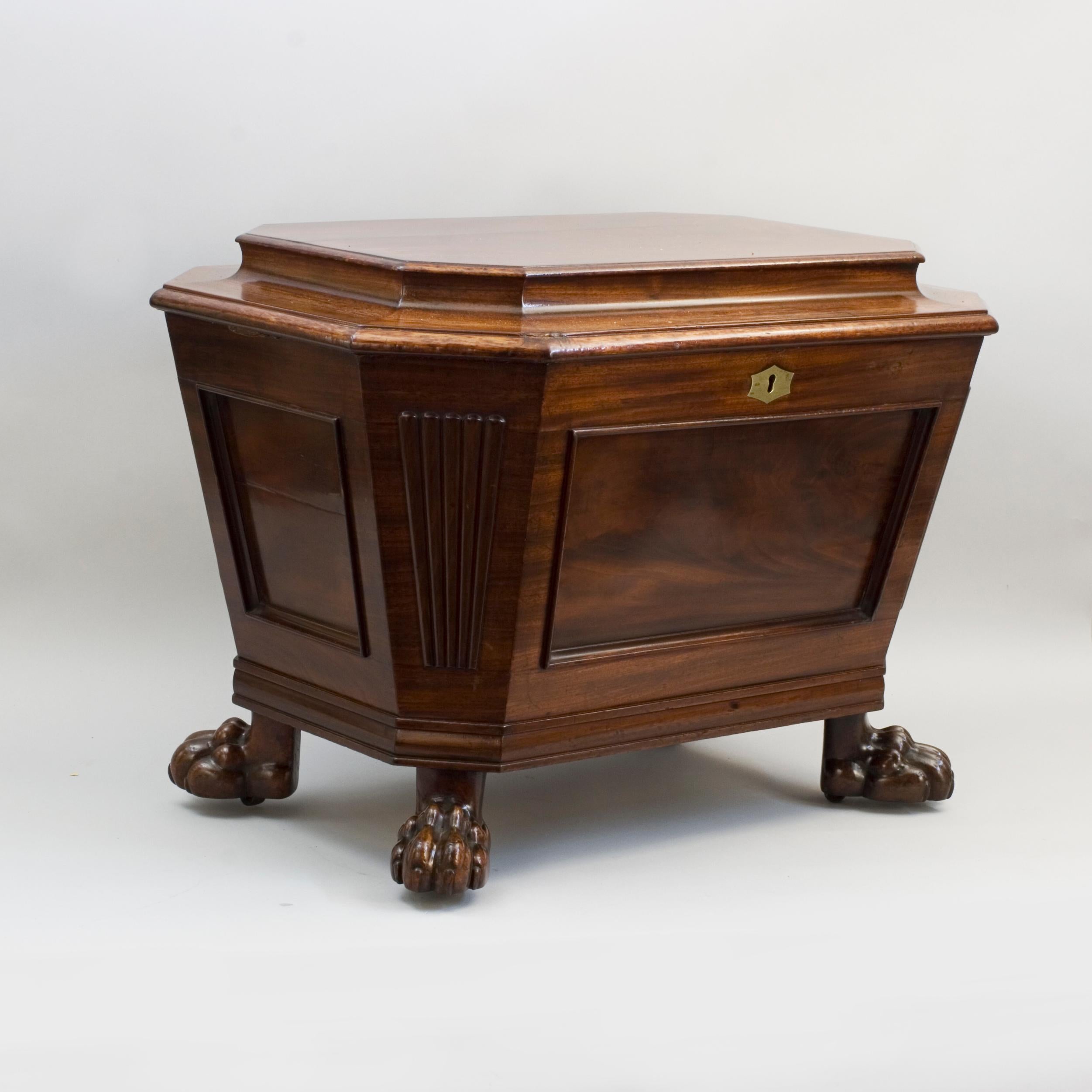 Regency Mahogany Sarcophagus Wine Cooler.
A superb quality Regency mahogany wine cooler, champagne cooler of sarcophagus form with a cavetto moulded hinged top lid, opening to reveal the original lead lined interior. The tapering body having cut