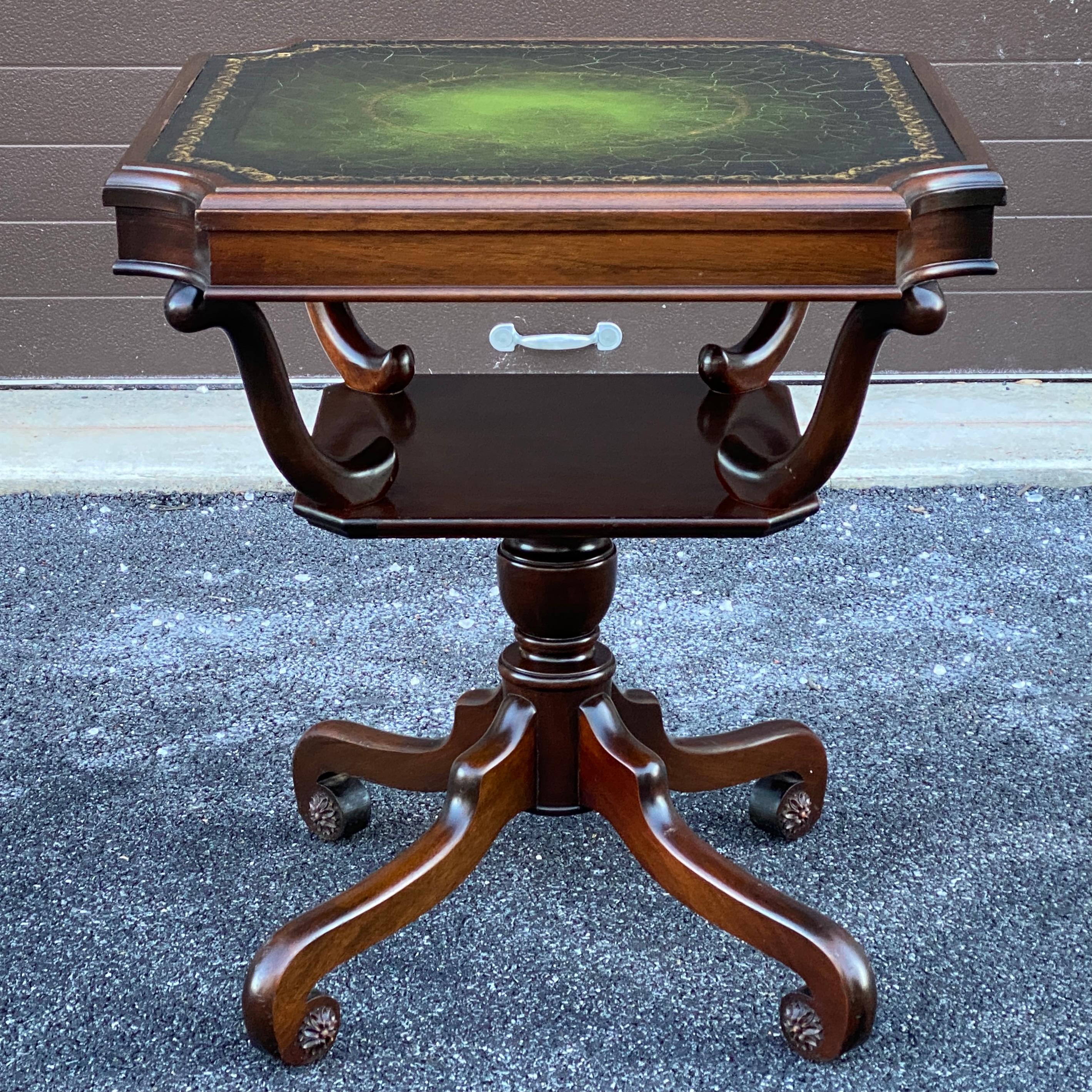 Green leather top mahogany center table with scroll feet circa early 20th century unmarked. 
8” shelf clearance.
