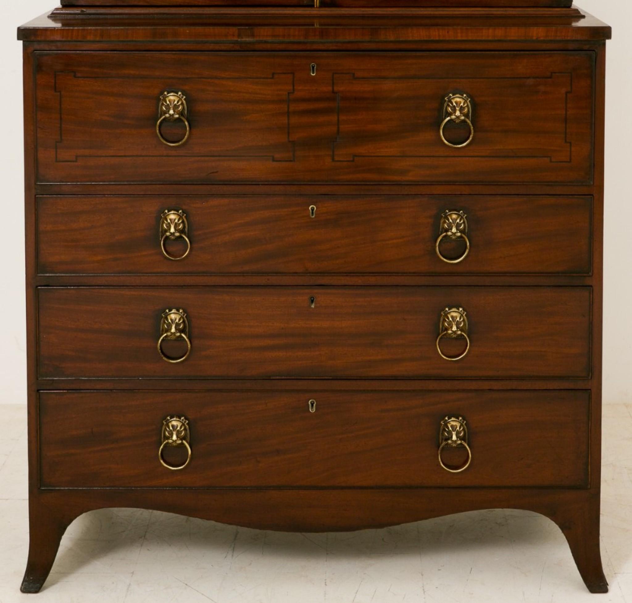 Regency Mahogany Secretaire Bookcase, standing on splay feet with graduated drawers above featuring original sphynx style handles and typical Regency ebony inlays.
circa 1800
The interior having a tooled leather writing surface and an arrangement