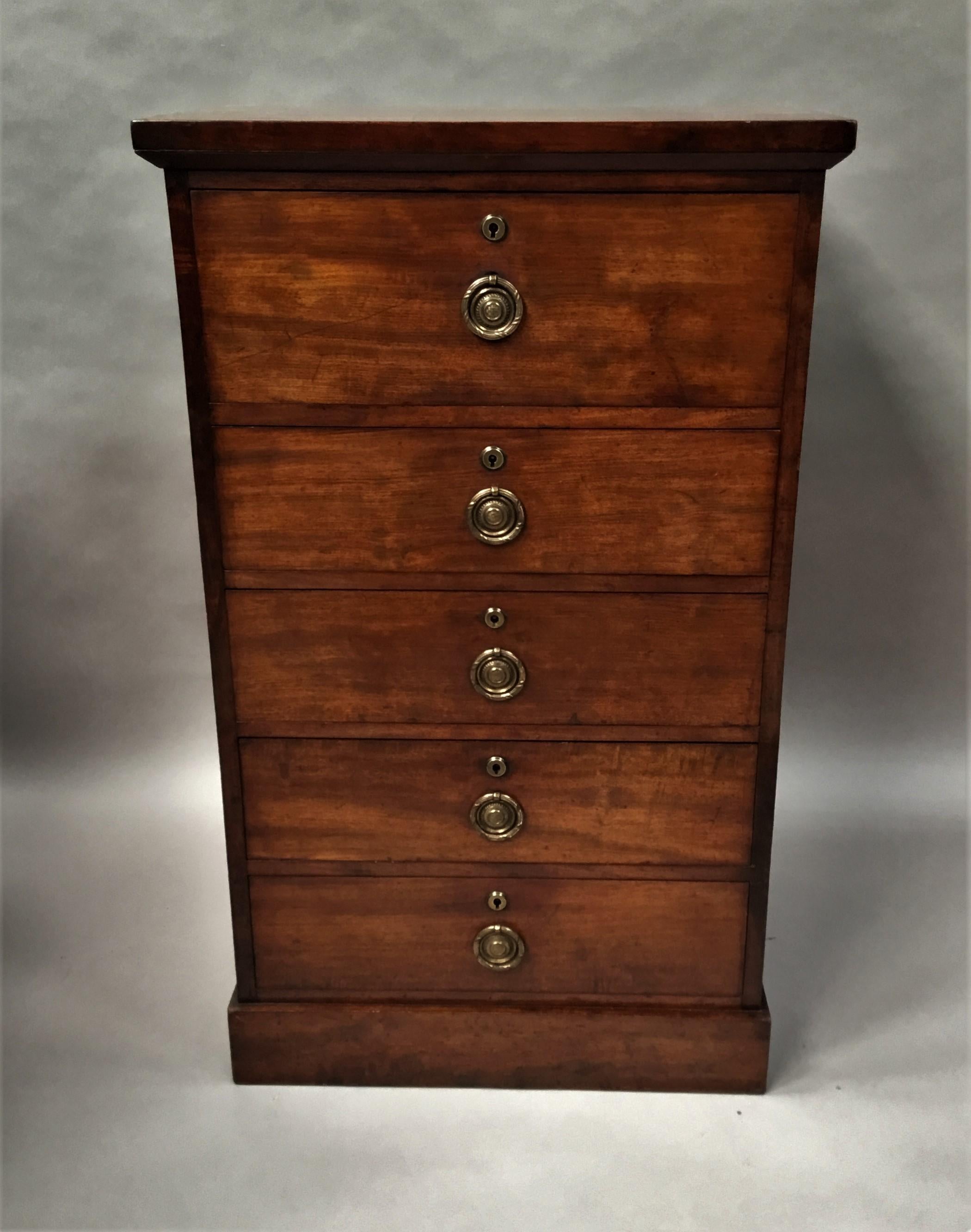 A good late Regency mahogany secretaire chest of drawers/pedestal cabinet of unusual narrow proportions; the well figured rectangular top above the secretaire writing drawer with typical hinged front and brass release catches revealing the fitted