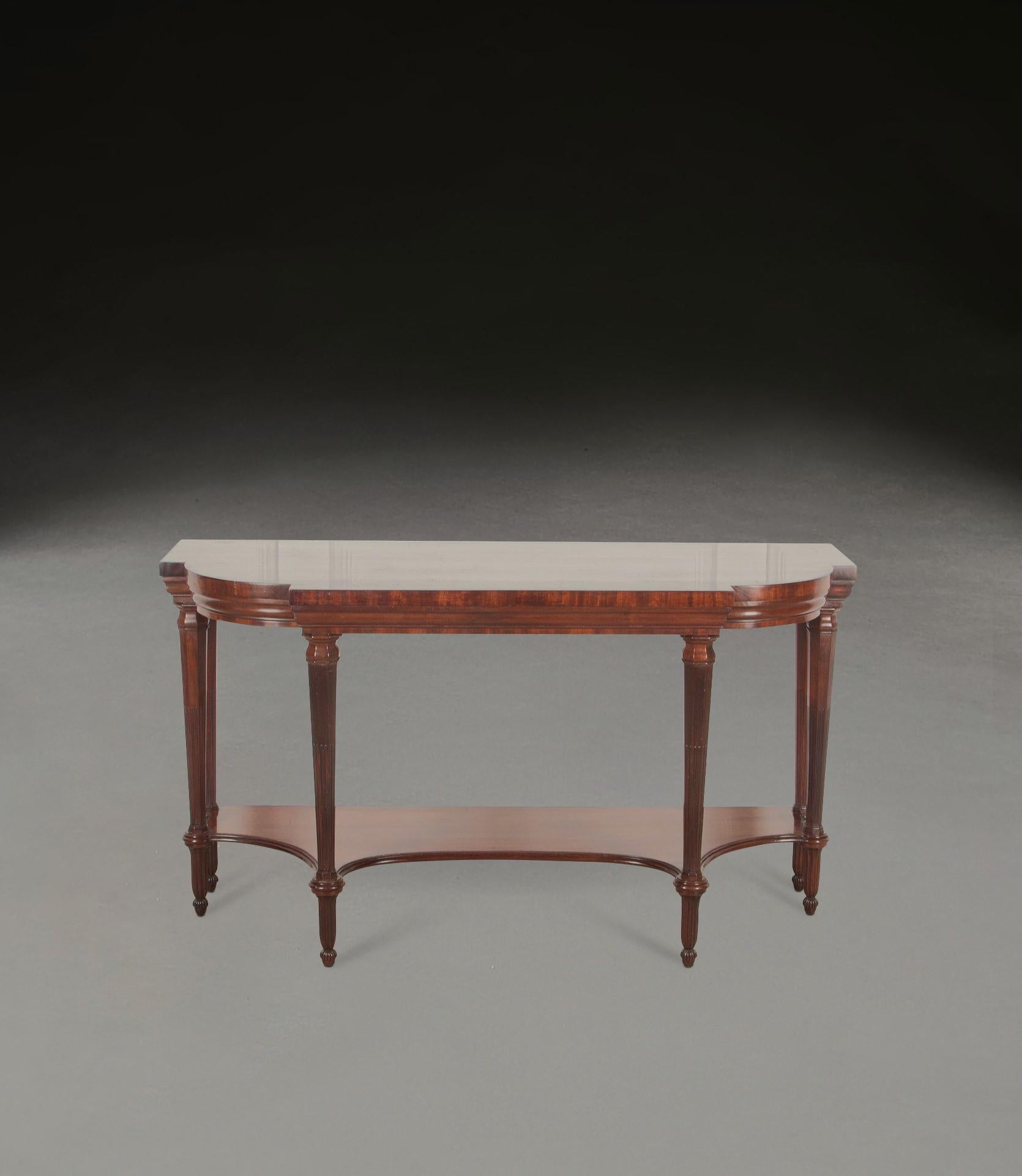 Regency Mahogany Serving Table of very unusual form.
With rounded ends and moulded frieze. 
Raised on six tapering octagonal legs with reeded moulding and fluted toupie feet, joined by a concave undertier. 
Circa 1830. Stands very elegantly, of good