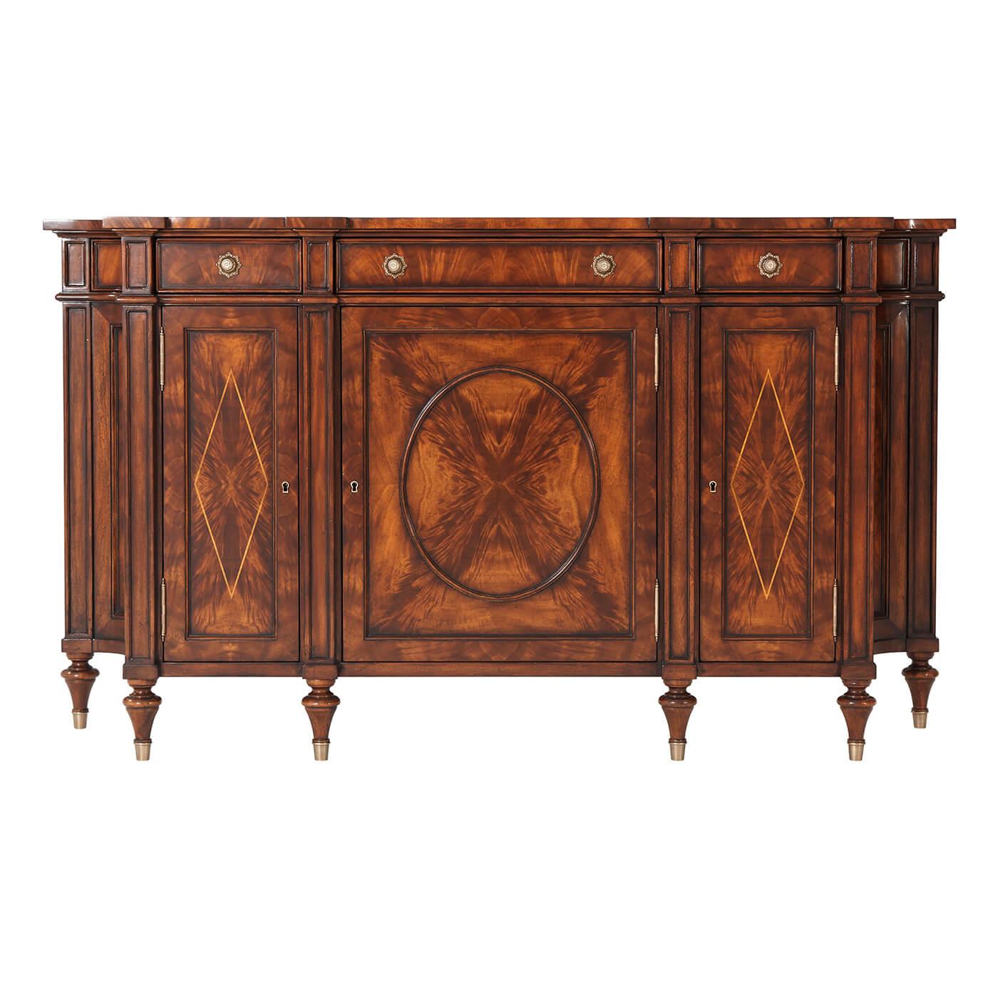 A fine Regency style mahogany and burl mahogany banded side cabinet, with three frieze drawers above corresponding oval panel and lozenge inlaid doors enclosing adjustable shelves, with concave sides, on turned legs with brass cappings.