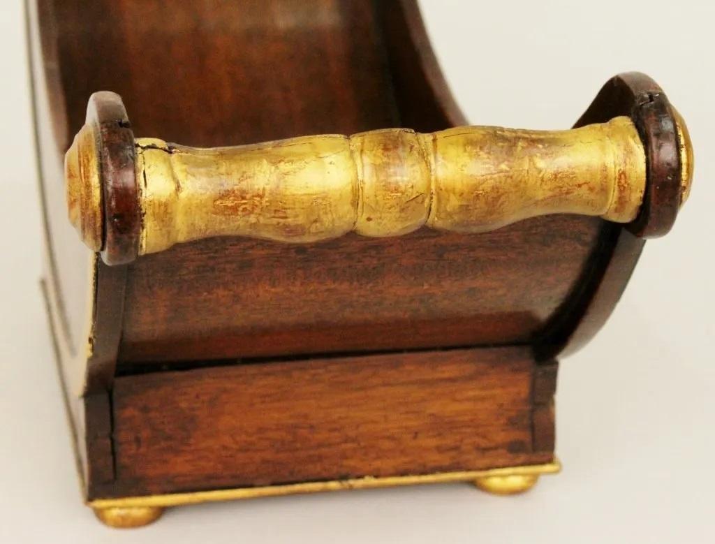 Regency Mahogany planter/display bowl in sleigh form. Gilt banding, handles and medallions decorations. Raised on four squat gilt feet,

19th century.