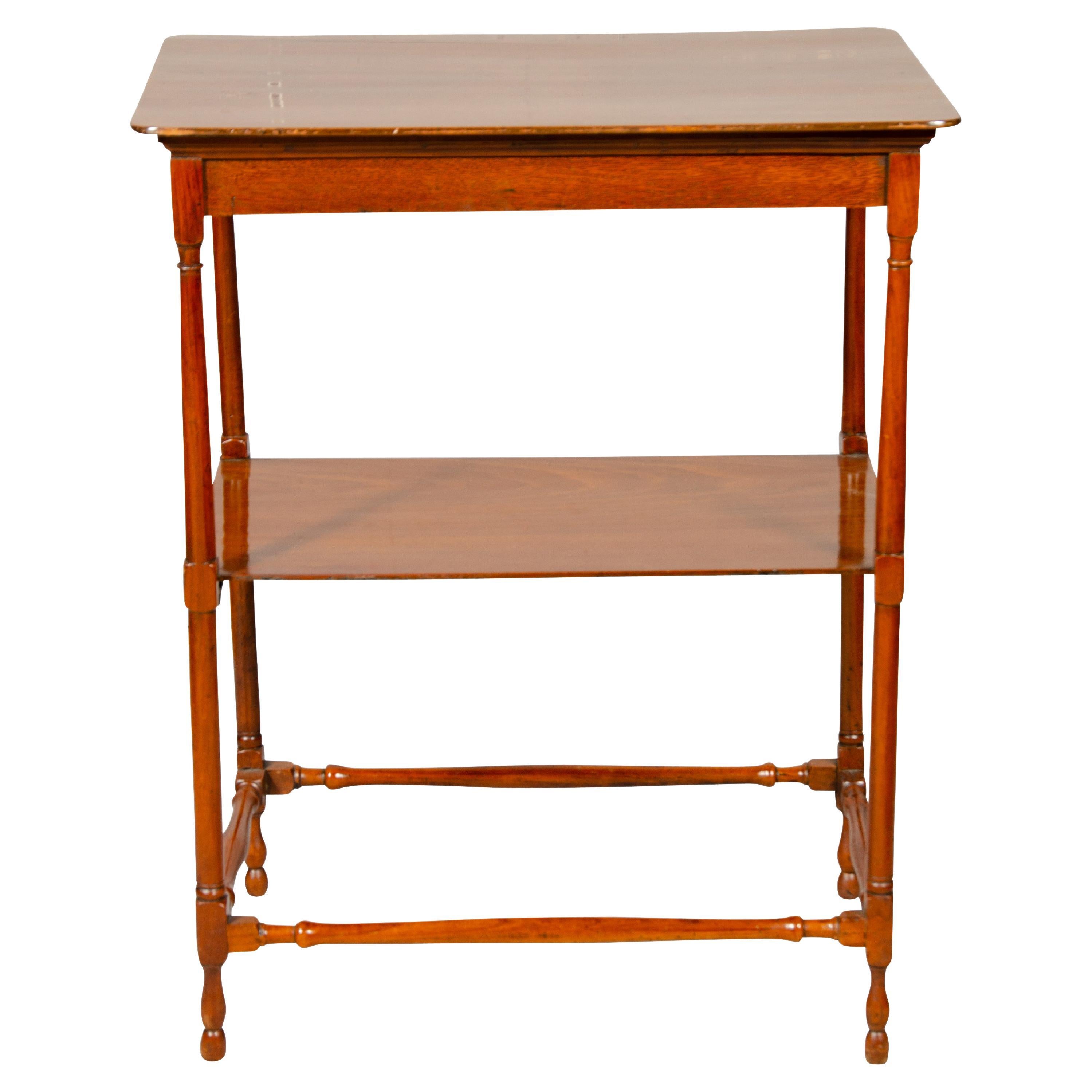 Rectangular top with conforming lower shelf, spindle legs and stretchers.