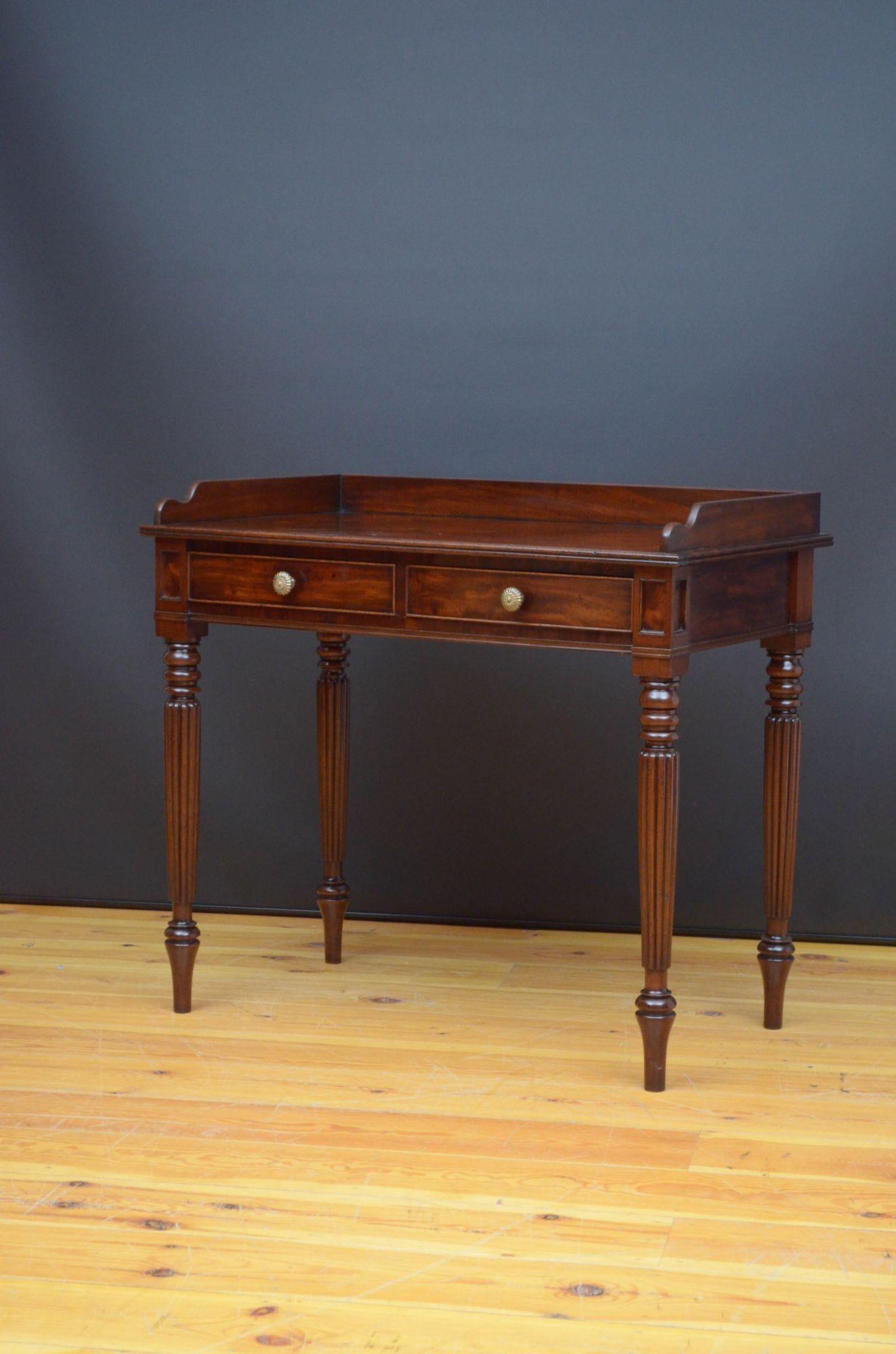 Sn5332 Superb quality Regency writing or dressing table in mahogany, having original upstand to the back, beautifully figured top with reeded edge and two cockbeaded and oak lined drawers fitted with original brass handles and flanked by moulded