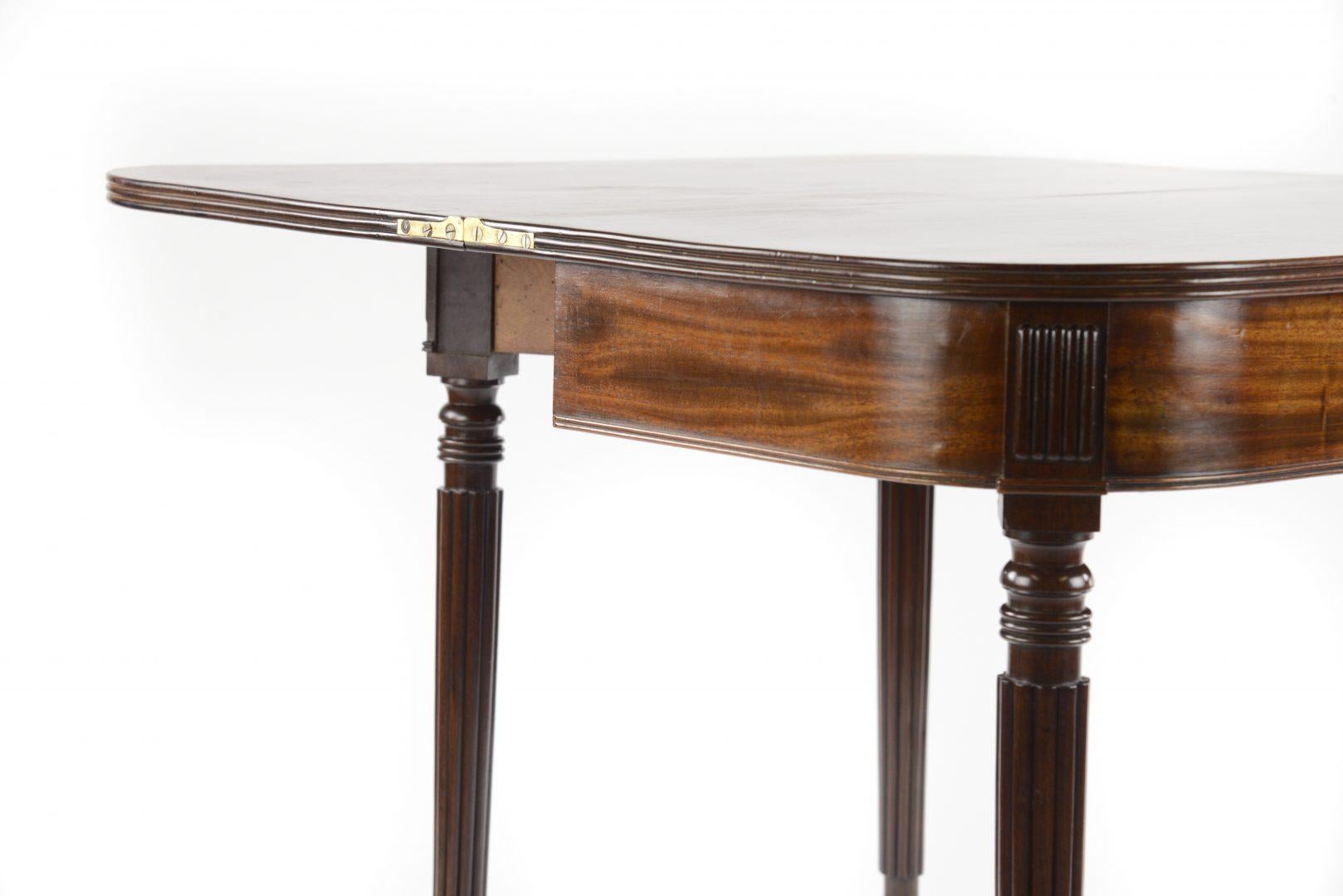A Regency mahogany turnover top tea table, attributed Gillows, raised on turned tapered reeded legs terminating in brass castors.

Gillows of Lancaster and London, also known as Gillow & Co., was an English furniture making firm based in
