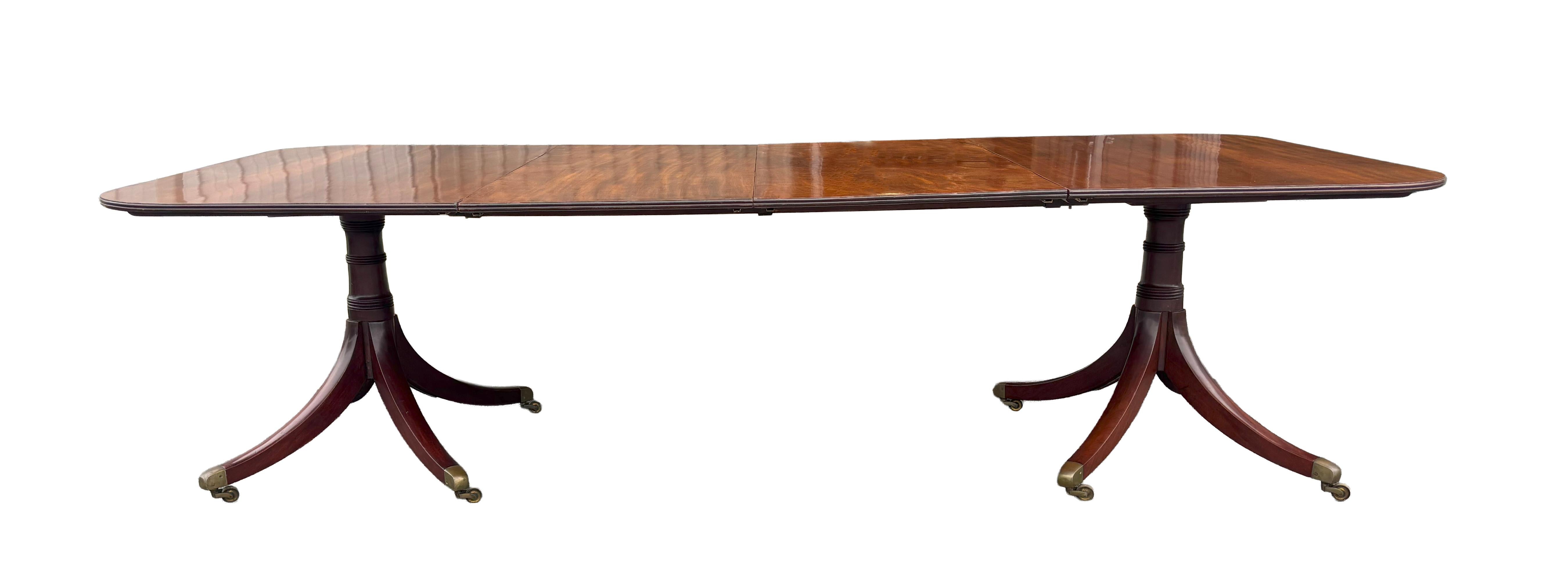 With finely figured and rich looking top with nice old growth timber with nice lightly faded appearance. Two leaves. Raised on turned supports and each pedestal with four saber legs ending on cup casters.