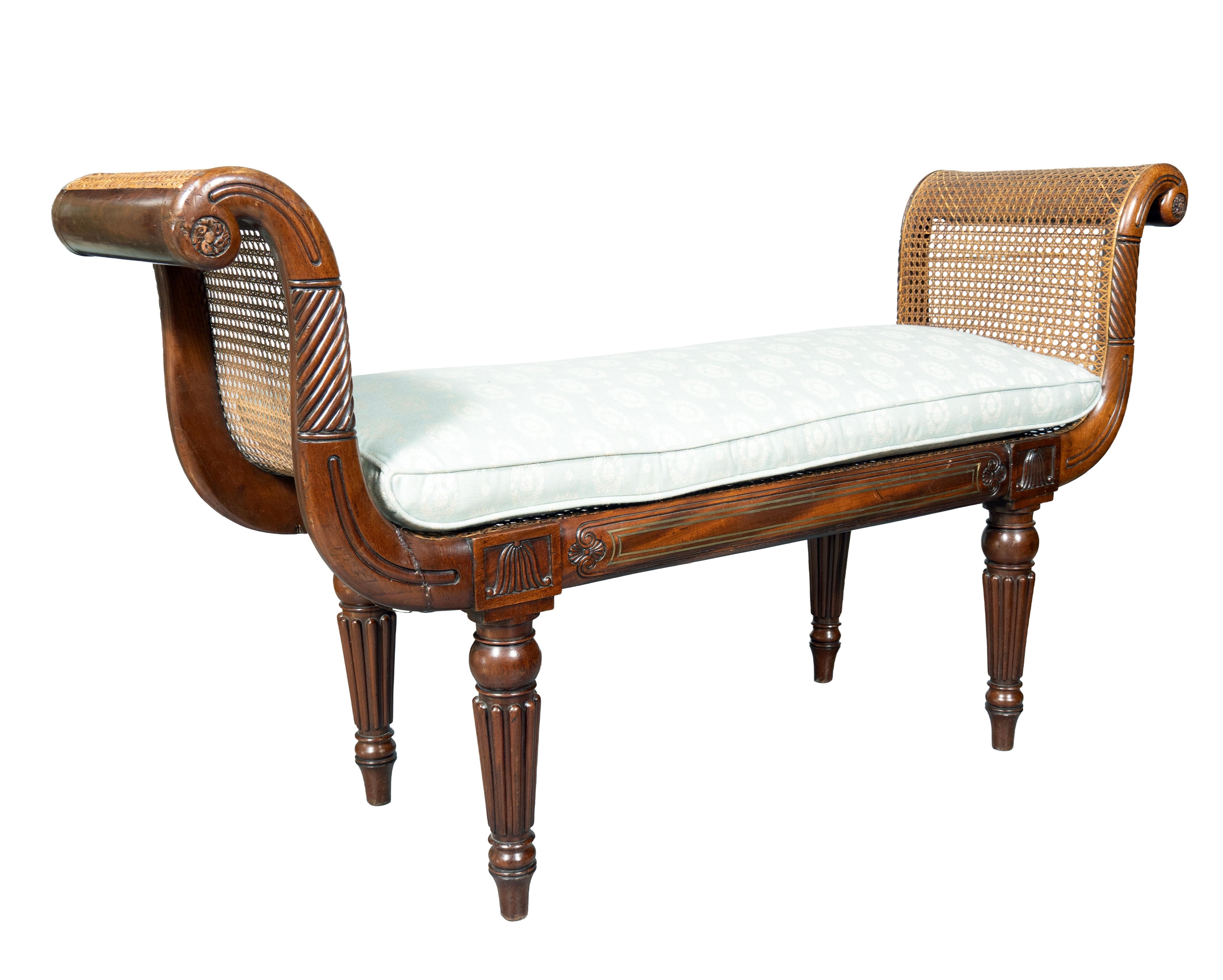 Seat height excludes cushion. Classic form with carved scrolled arms and frame. The seat rail with brass stringing. Circular reeded tapered legs. Caning on seat and arms in very good condition.