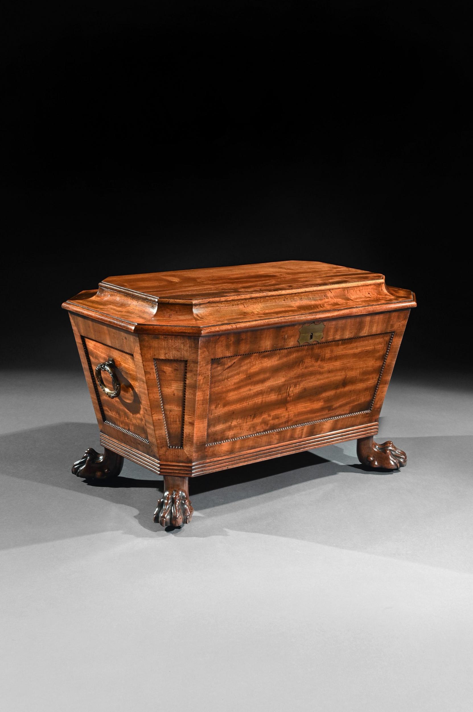 A very fine 19th century Regency mahogany wine cooler cellarette of sarcophagus form and wonderful natural color.

English, circa 1820

Having obtained a wonderful natural color, the whole of sarcophagus form with a cavetto moulded hinged top