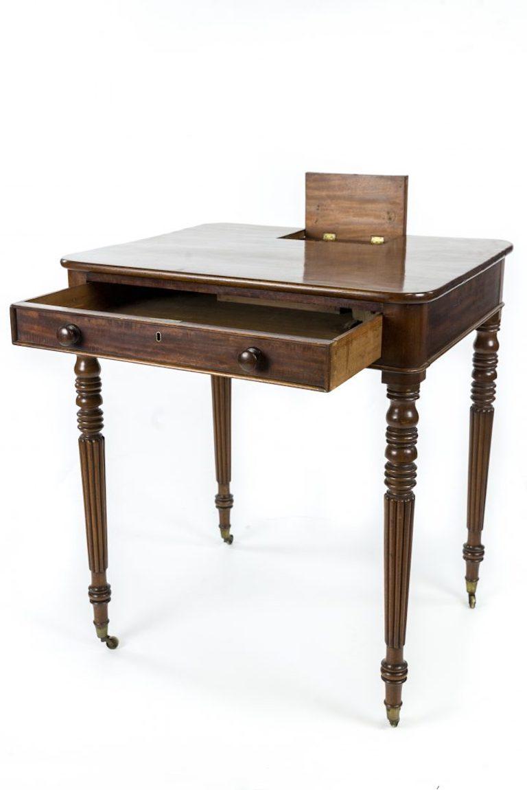A Regency mahogany writing table, signed ‘Gillows, Lancaster’, ‘the rounded corner top with hinged compartment above a frieze drawer and reeded tapering legs


Gillows of Lancaster and London, also known as Gillow & Co., was an English furniture