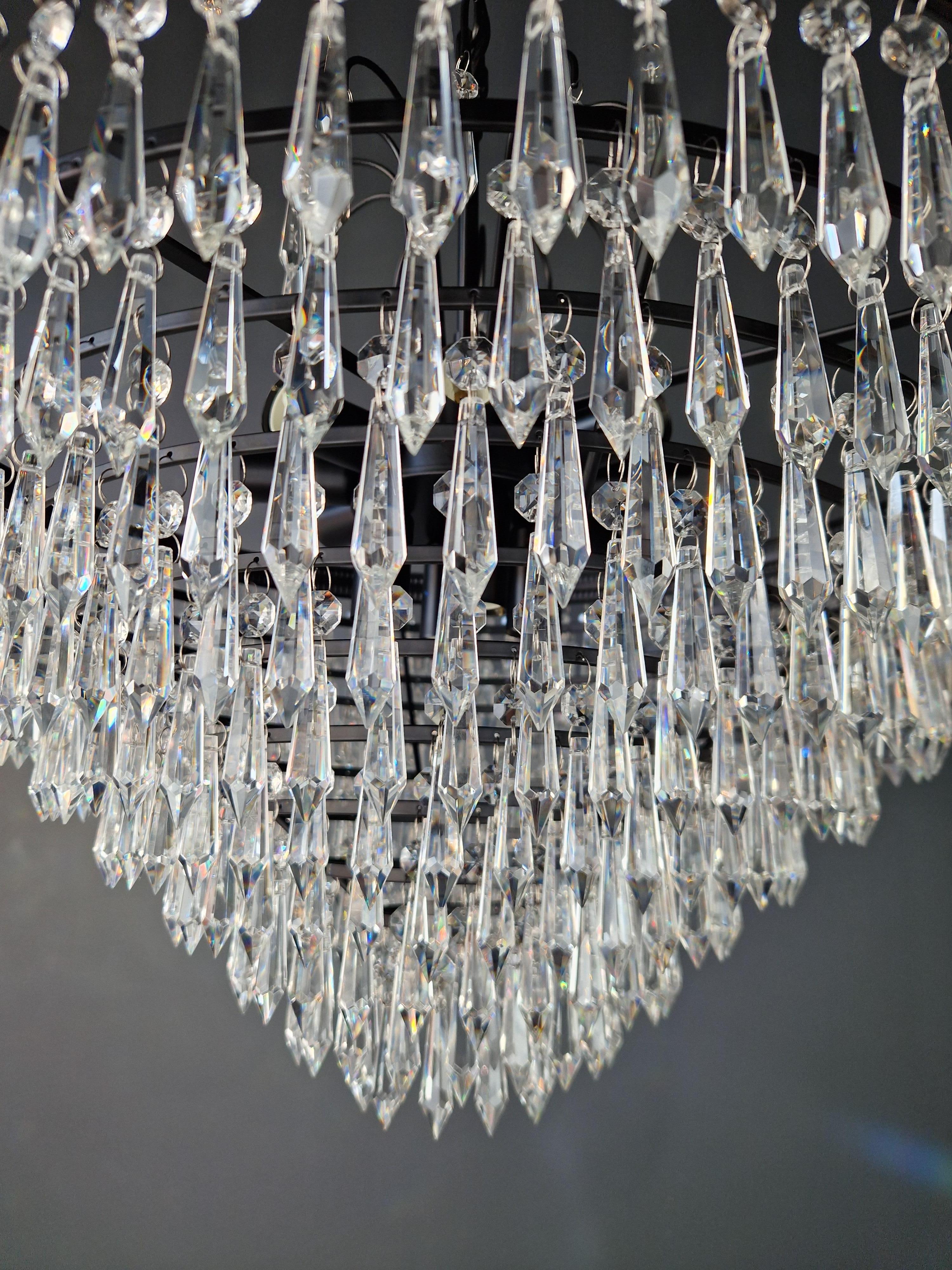 our lead crystal chandelier is a testament to opulence and craftsmanship. Crafted in-house, we offer the flexibility of both smaller and larger sizes, ensuring the perfect fit for your space. Our team can even facilitate on-site installation,