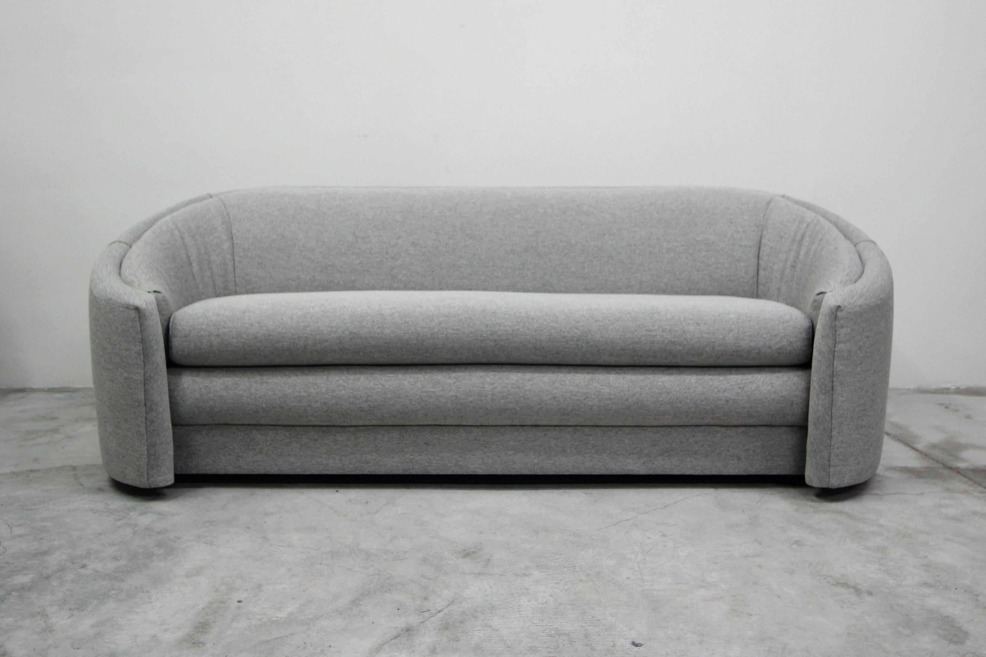 The perfect midcentury sofa with hints of regency style swag. If you've been looking for that perfect sofa that can mesh into several styles this beauty will not disappoint. Her lines and curves give her mass appeal and her perfectly rounded