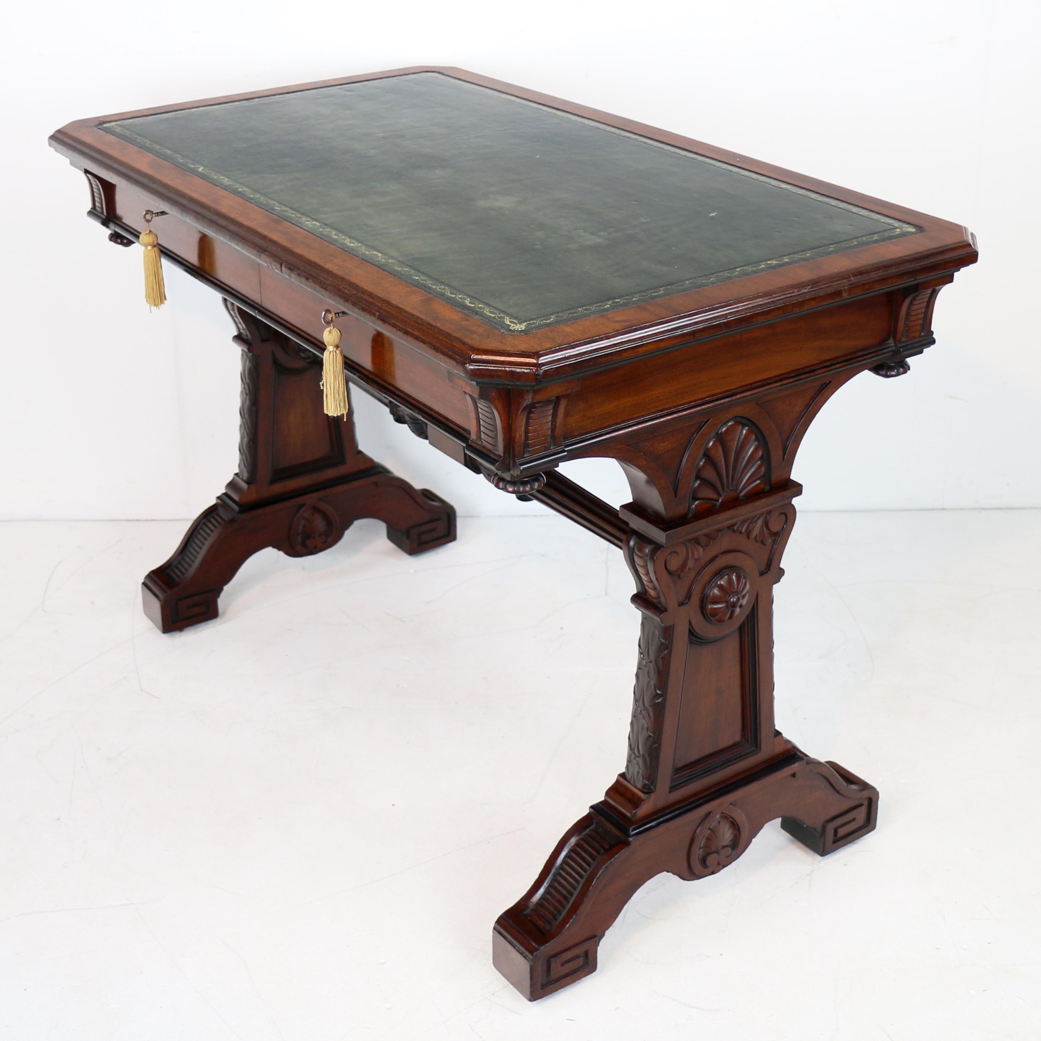 A superb quality late Regency mahogany and ebonised library table in the manner of the architect and designer Richard Bridgens (1785-1846).  With a canted top with a green and gilt tooled leather inset writing surface above two mahogany lined frieze