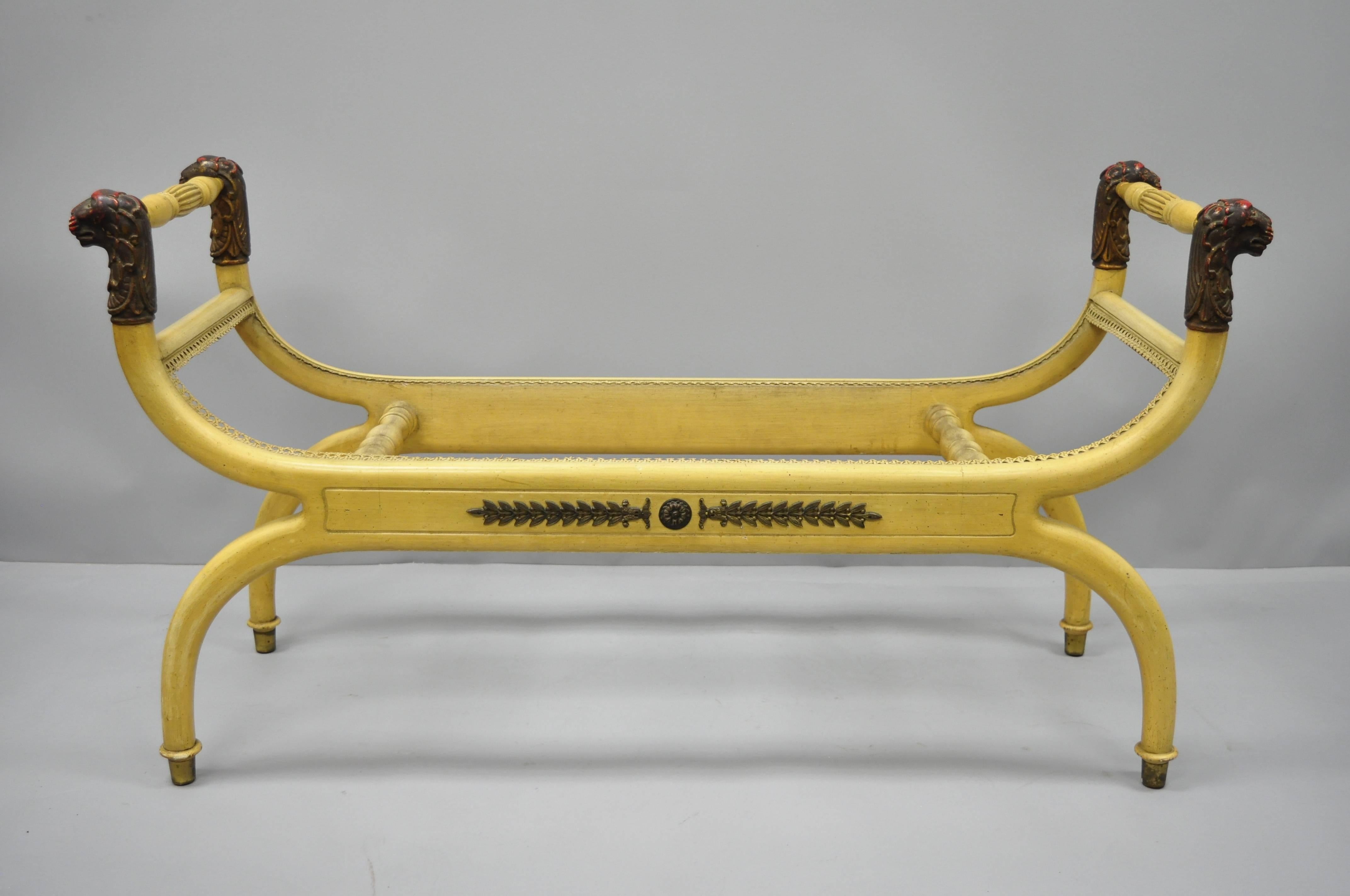 Vintage Regency neoclassical style lion head curule long bench by Bruschi & Rolando. Item features carved lion heads, solid wood construction, nicely carved detail, original tag, brass accents, great style and form. Originally had a cane seat, circa