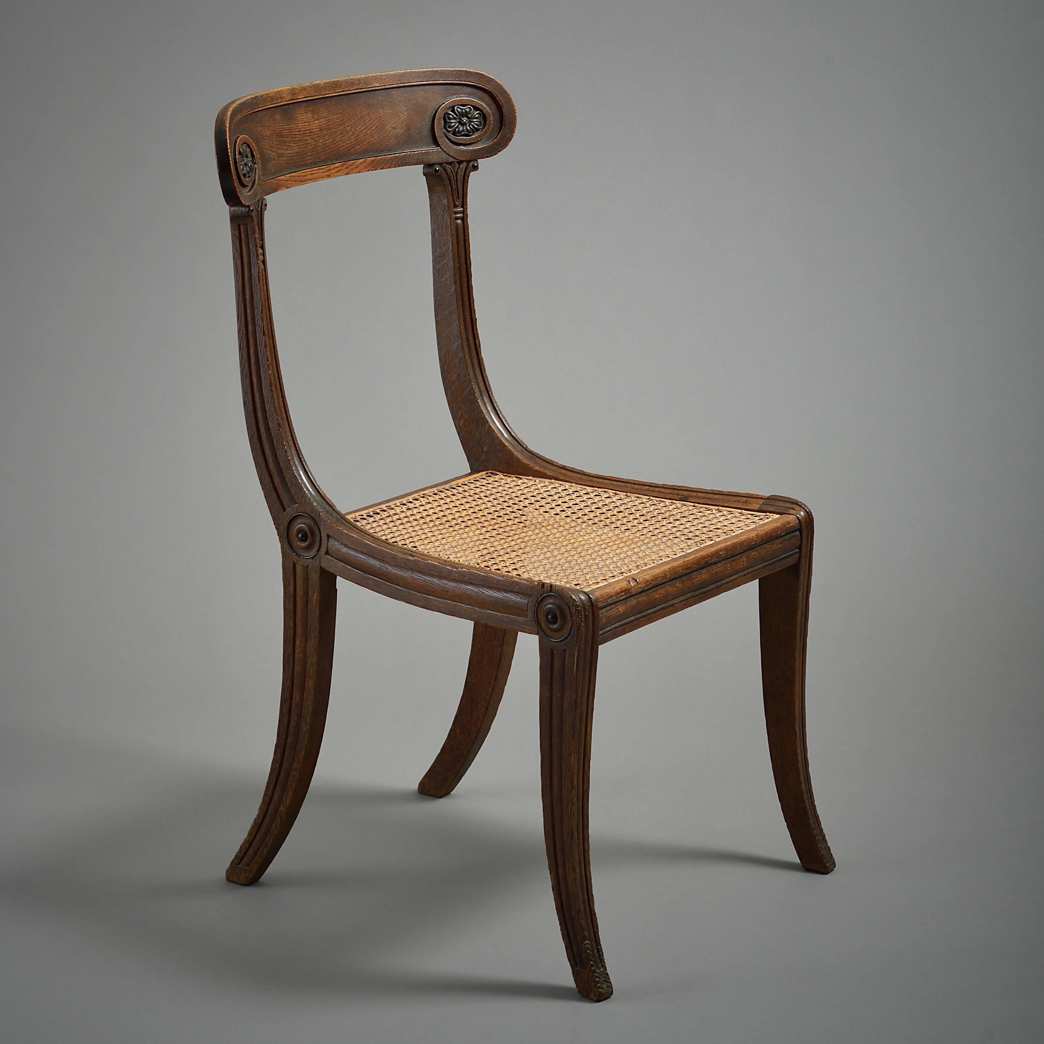 A Regency oak and ebonized chair with caned seat, circa 1810.