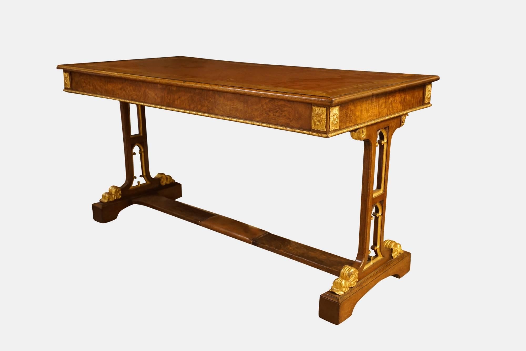A late Regency oak Gothic library table with gilded enrichments (in the manner of William Porden).