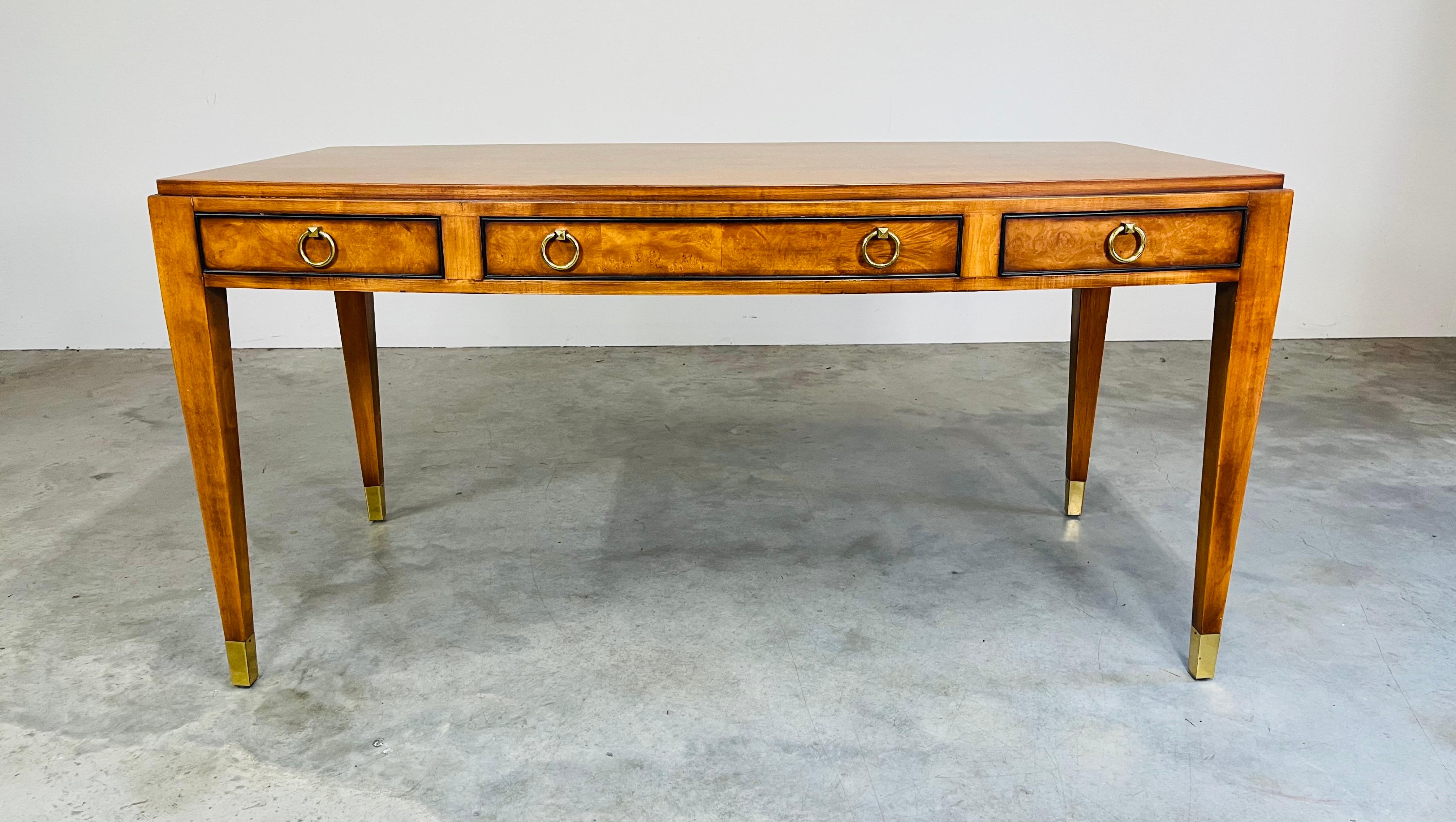 A beautiful regency style olive Burlwood executive desk by EJ Victor having diamond head brass loop drawer pulls revealing ample storage for legal pads and other necessities with matching brass sabot feet. In excellent condition having been