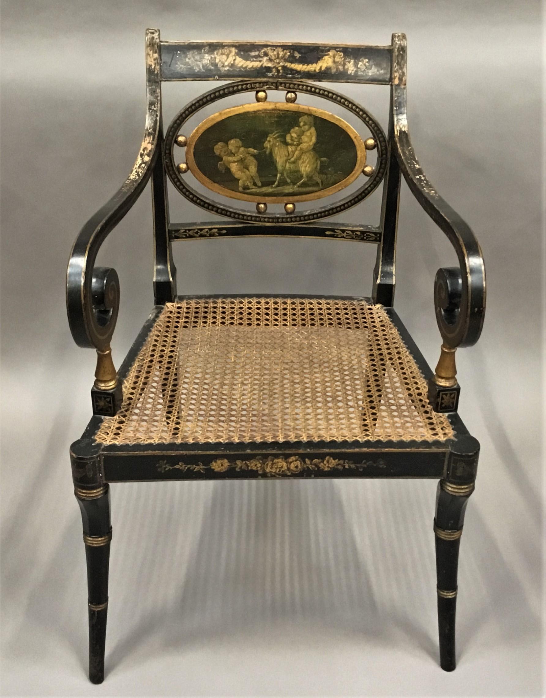 Good Regency painted and parcel gilt armchair of shapely form and retaining its original painted decoration; the top rail painted with a pair of cornucopia above an oval tablet painted with Grisaille scene of playful putti with a goat. The scrolled