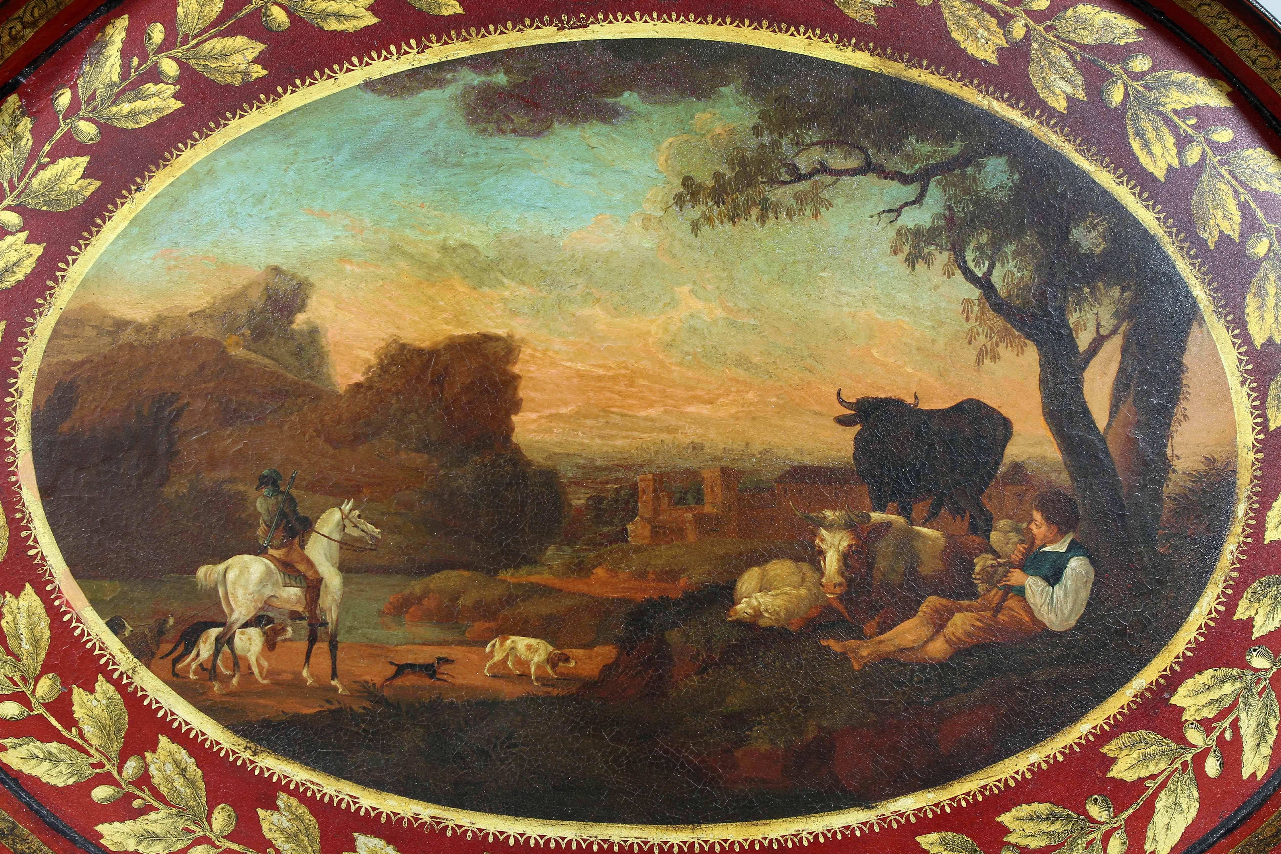 Oval mit rotem Grund und vergoldeter Blattspitze am äußeren Rand, schön gemalte pastorale Szene in der Mitte.