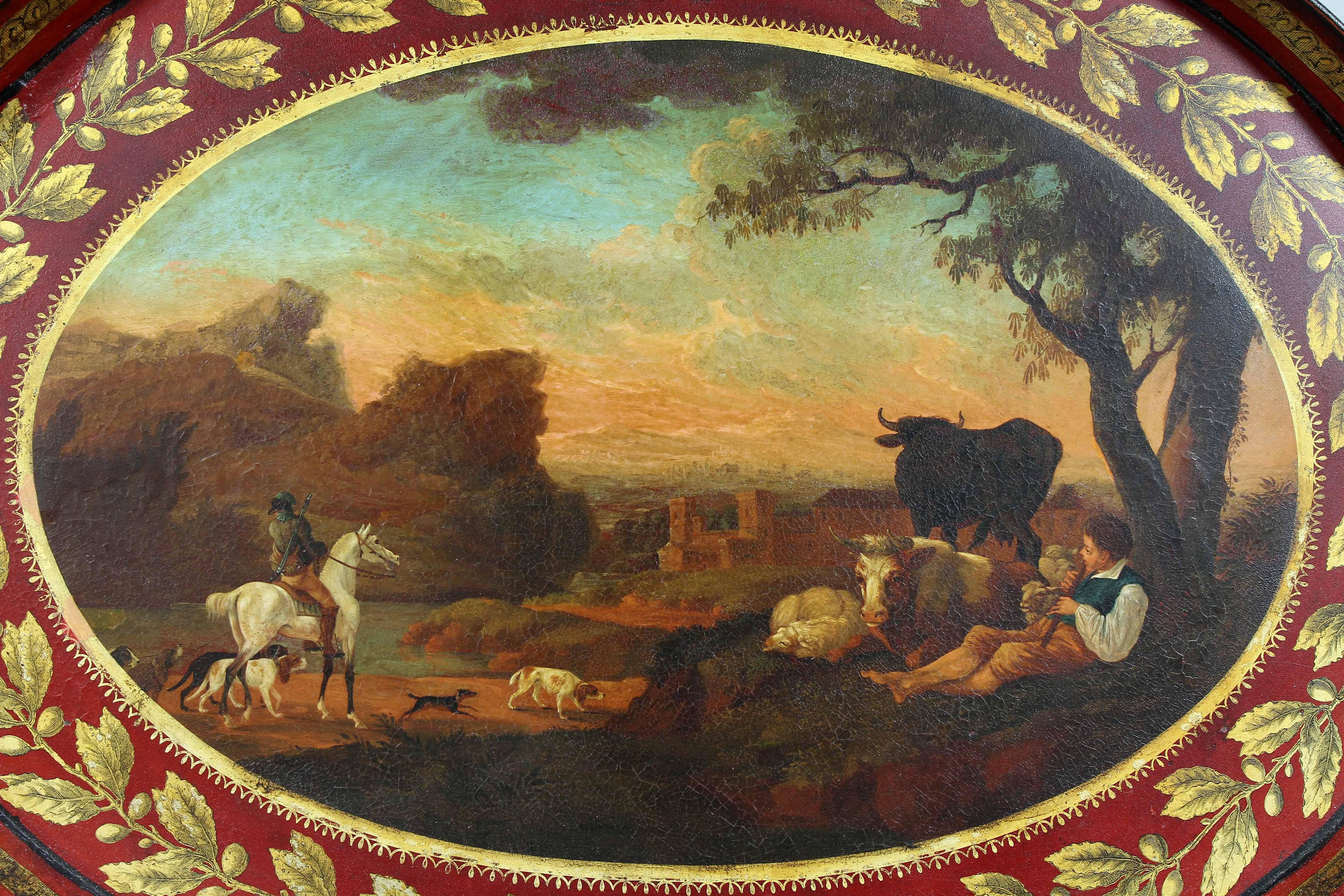 Ovale con fondo rosso e bordo esterno dorato a punta di foglia, scena pastorale centrale splendidamente dipinta.