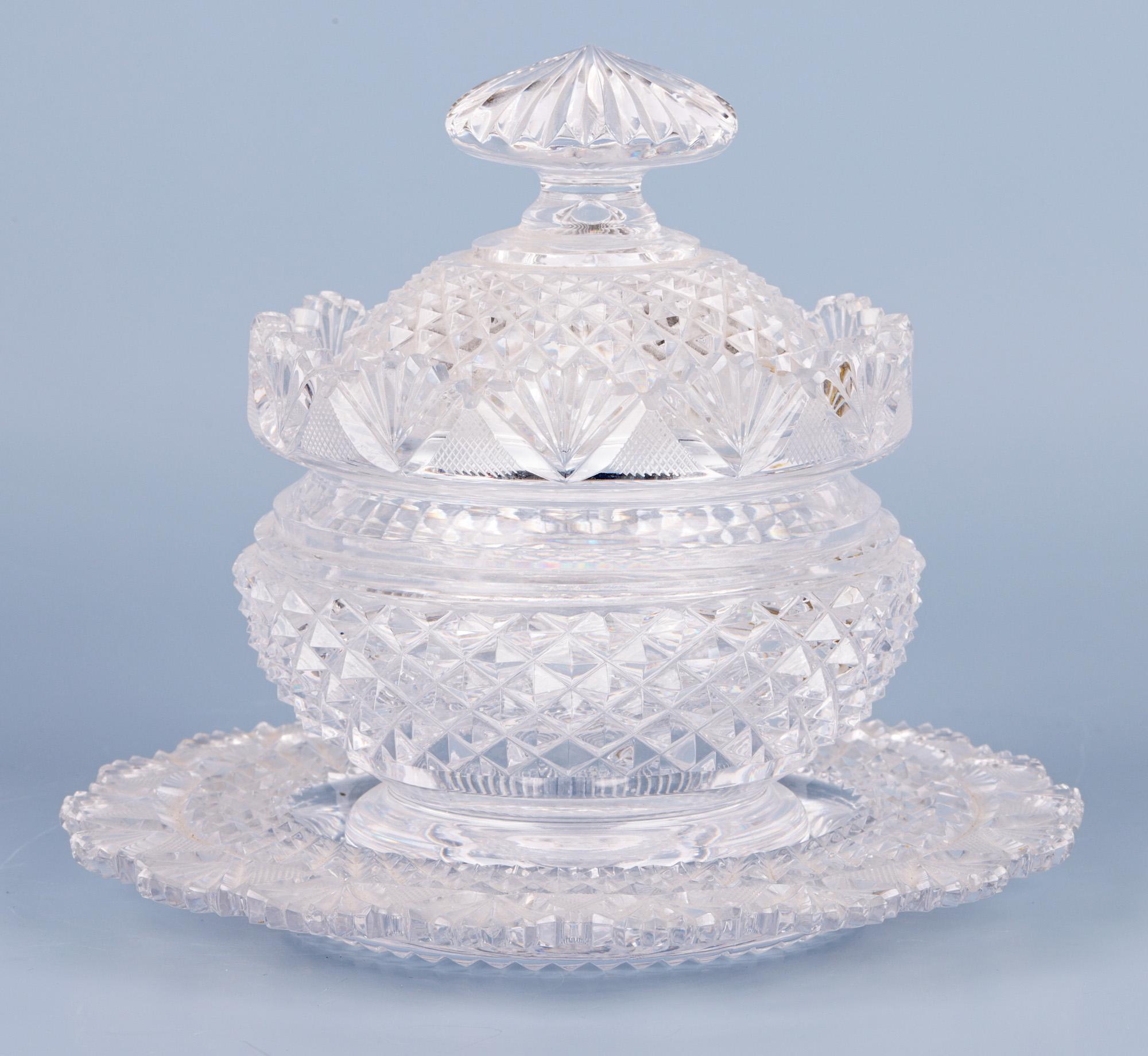 A very fine pair matching antique cut glass lidded butter dishes on matching stands dating from around 1825. The dishes are of wide rounded shape with narrow round cut bases with polished pontil marks which sit within the recess of the stands. The