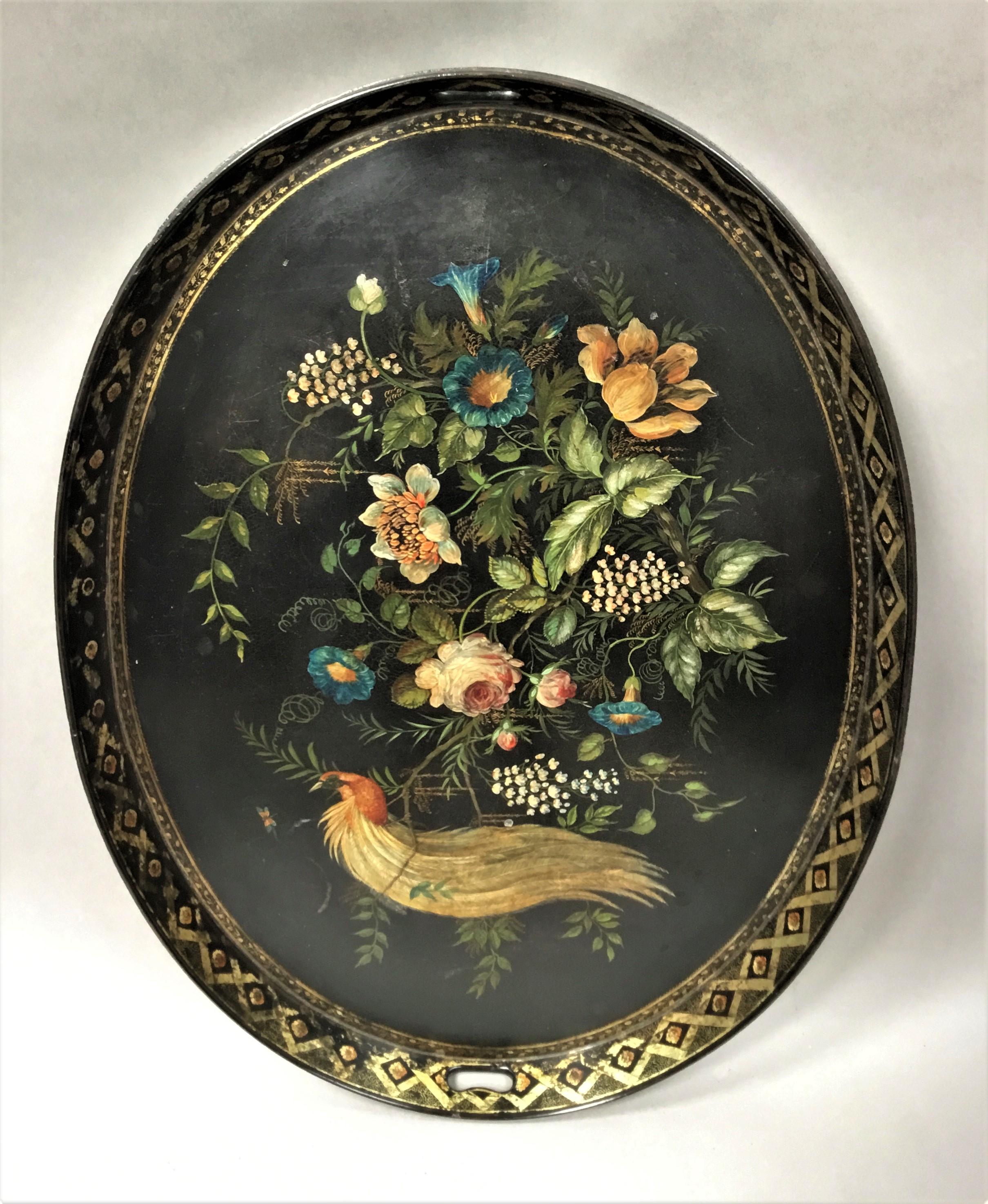 Good large Regency papier mâché tray on stand, of oval form and large proportions; the flared raised gallery with a slender moulded edge, with gilt decoration and pierced carrying handles to either side; surrounding a finely painted scene of a