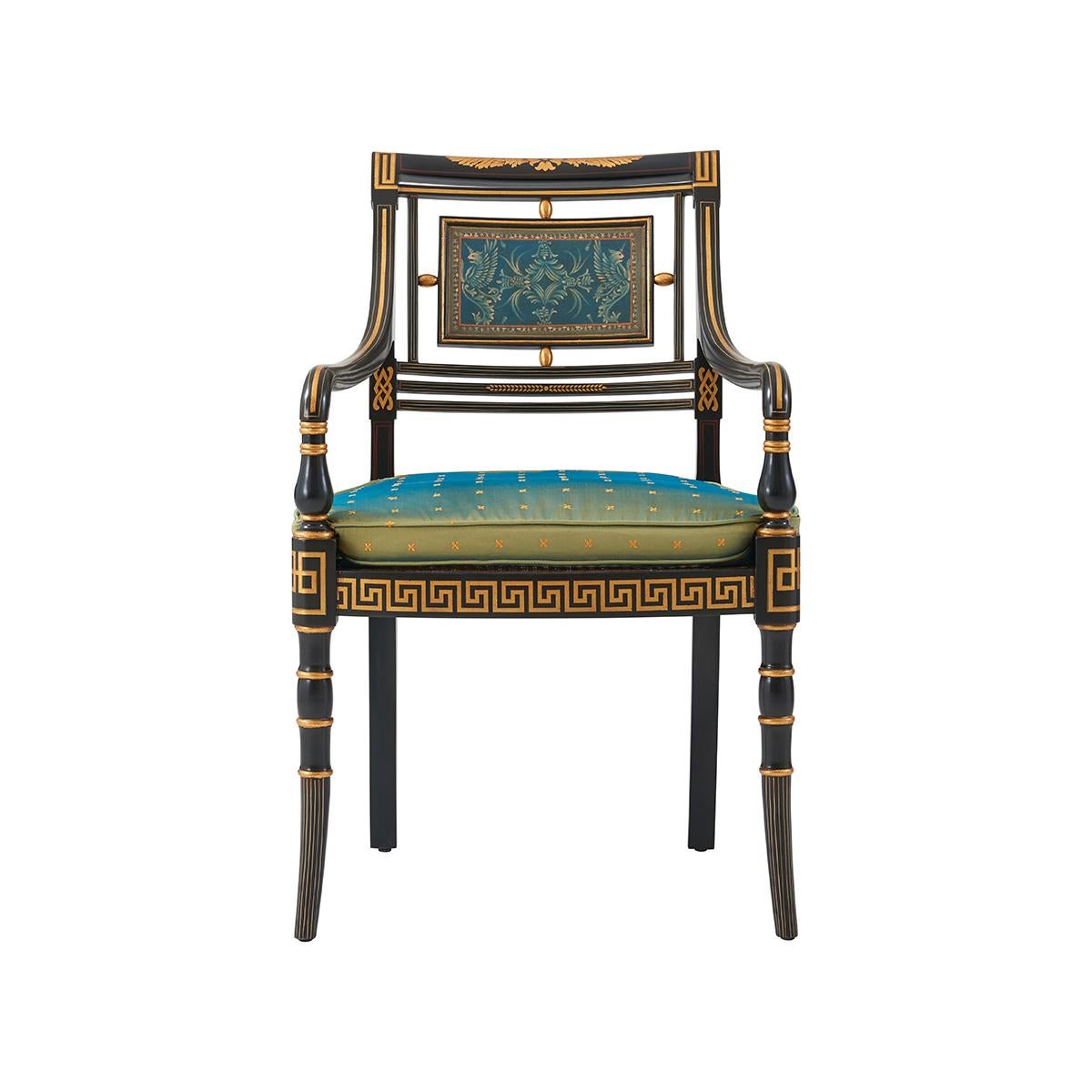 Sillón abierto de estilo Regencia, ebonizado y paquetería dorada, el respaldo sobre roleo centrado por un panel rectangular pintado, con canes y cojín sobre un riel de asiento de llave griega y sobre conos torneados en anilla. La Regencia original,