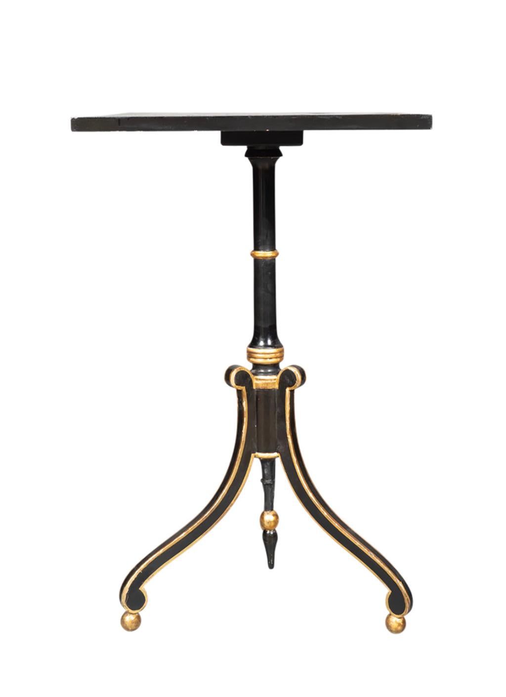 Square gameboard top with gilt and ebonized support and ending on three curved legs wit ball feet.
