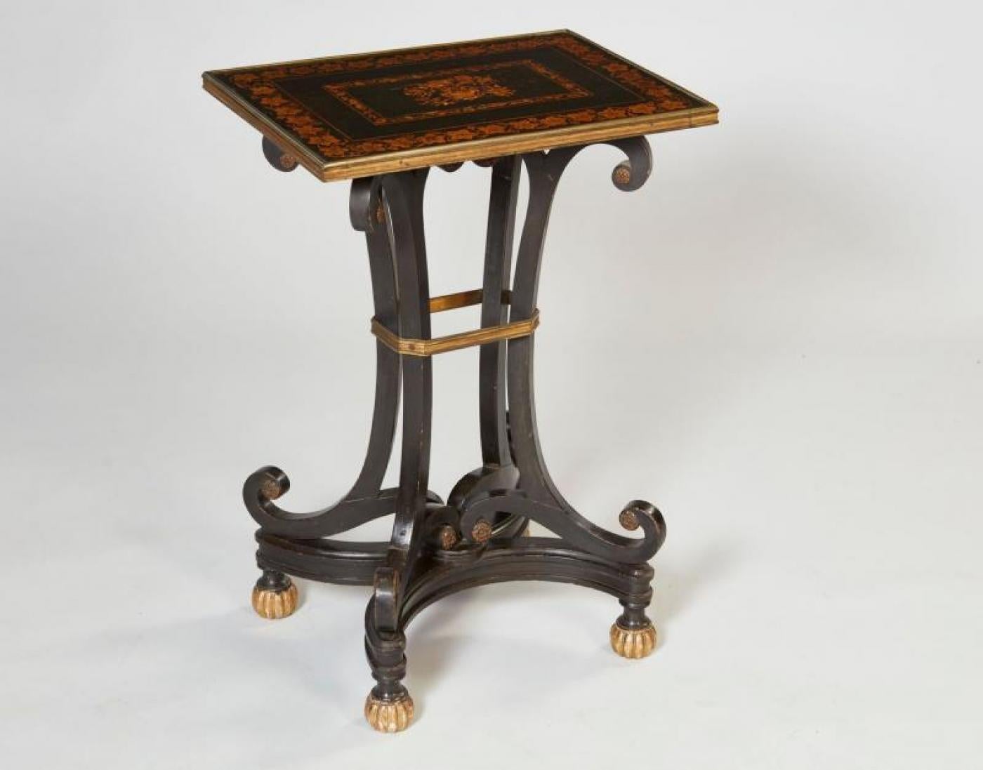 Very fine Regency period side table having a penwork decorated top with chased gilt bronze molded edge over curule legs joined by gilt bronze band and standing on scrolled base with ribbed giltwood ball feet, the whole retaining original painted