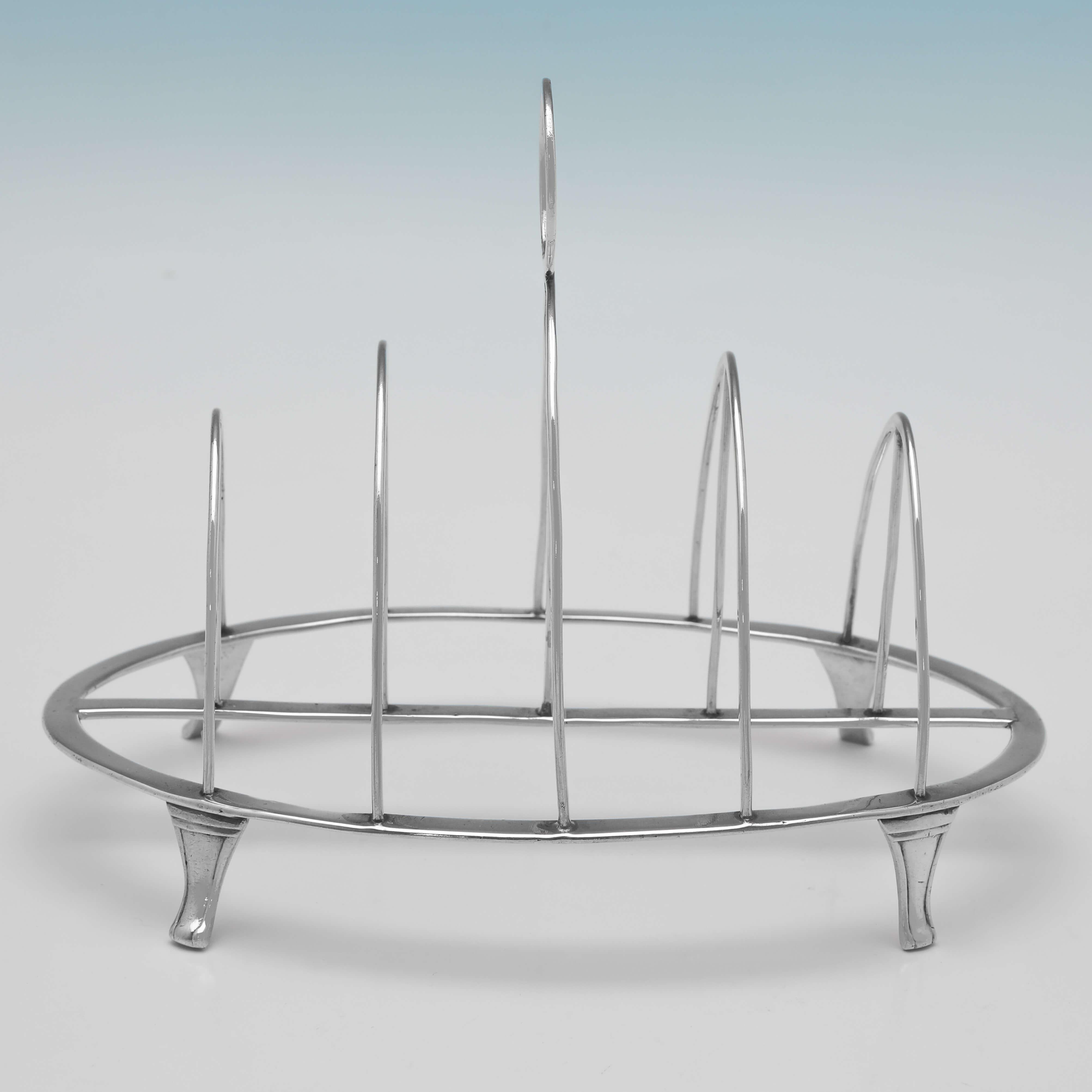 Hallmarked in London in 1812 by Samuel Hennell, this handsome, Regency Period, Antique Sterling Silver Toast Rack, is plain in design, and will hold 4 slices of toast. 

The toast rack measures 5