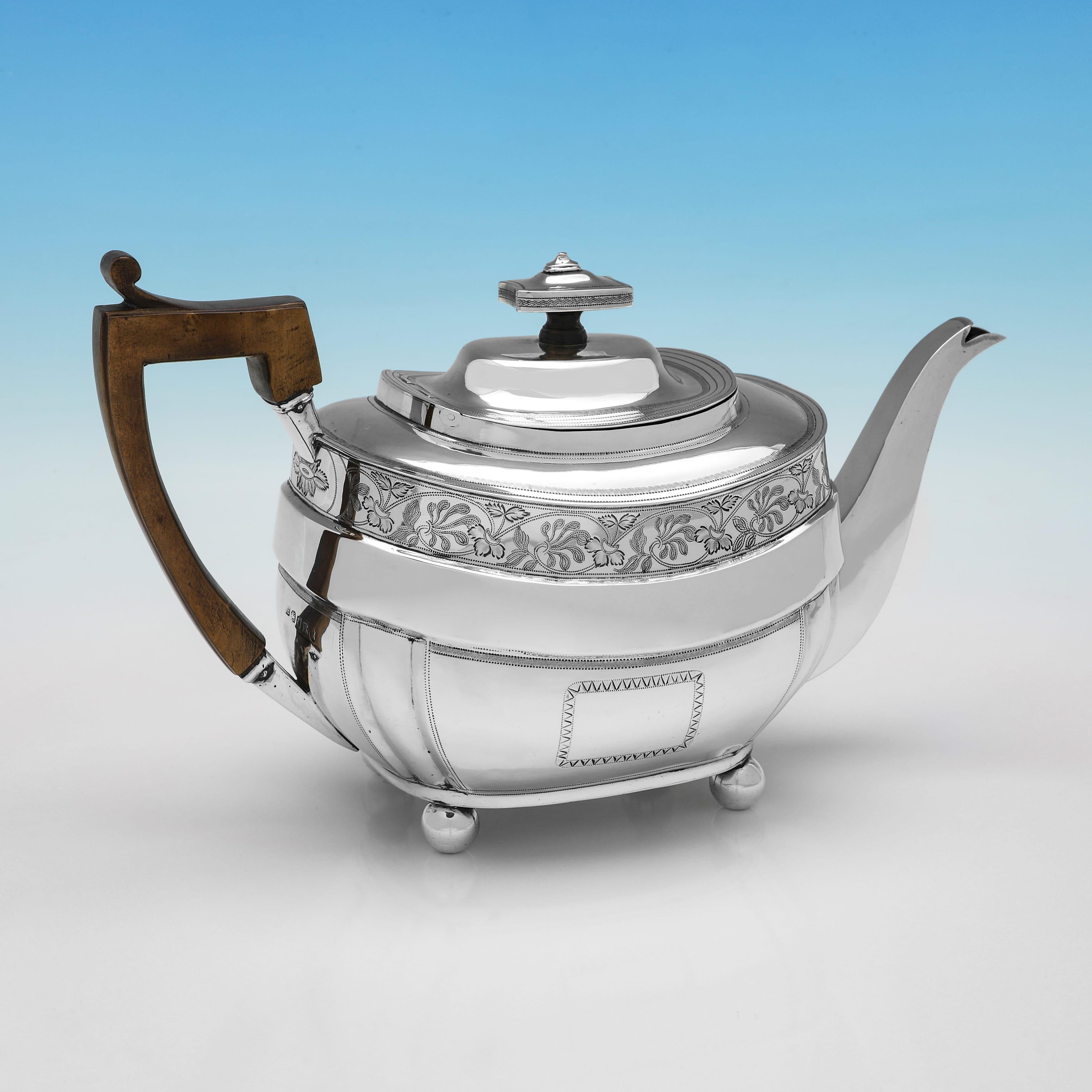 Hallmarked in London in 1812 by William Hall, this attractive, Regency Period, Antique Sterling Silver Teapot, features wonderful bright cut engraved decoration, and a wooden handle. The teapot measures 6.5