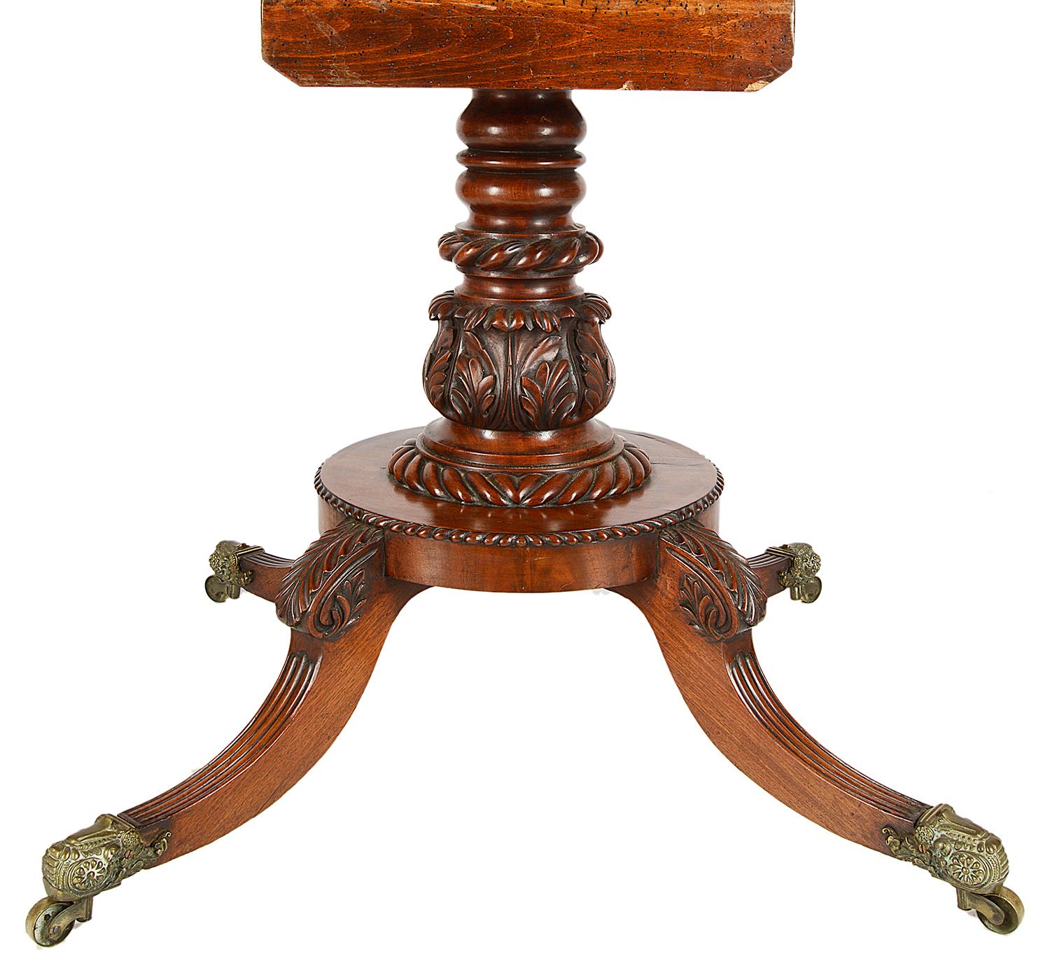 A good quality Regency period mahogany centre table with a crossband top. Raised on a carved central pedestal and a four splay base.