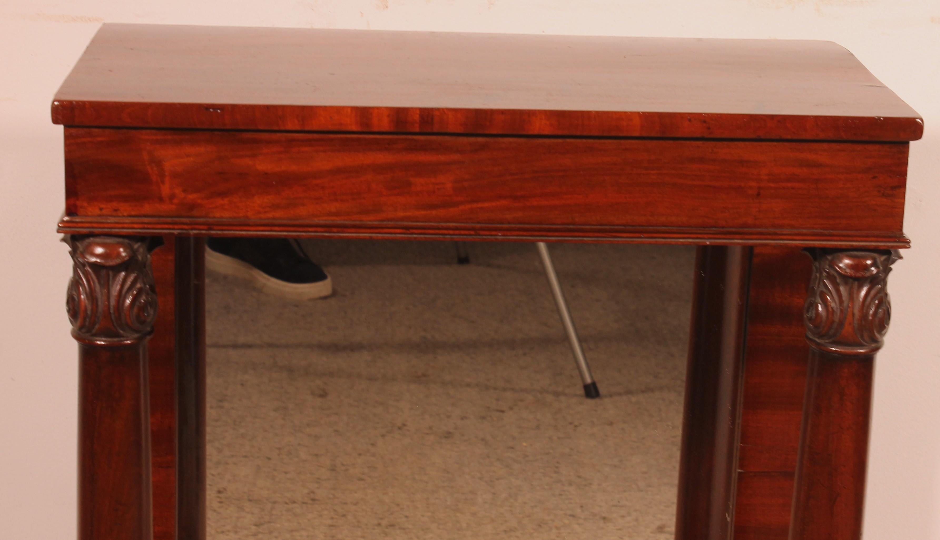 a fine Regency period console table from the early 19th century, circa 1820.

A very beautiful and unusual small model with a mirror at the back with is rare and give here a lot of charm.
It features a square top and rests on a plinth
It has two