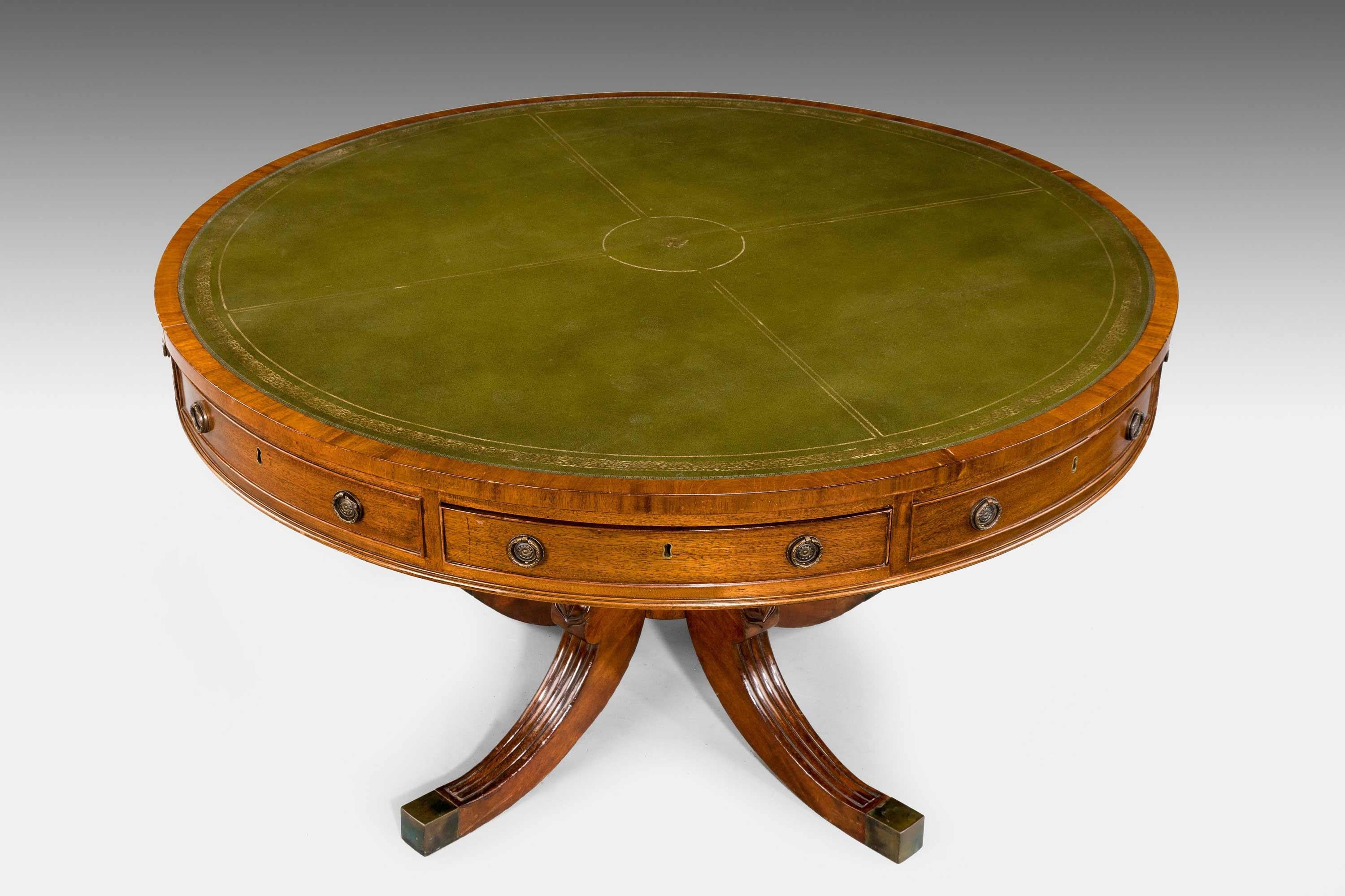 A very good Regency period circular drum or rent table with four real drawers and four mock drawers on very well carved baluster support with four shaped sabre legs reeded and carved.
 